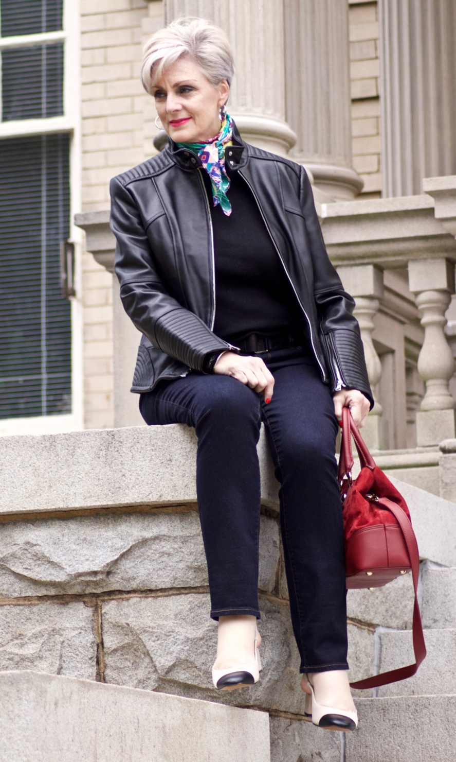 leather moto jacket, black sweater, silk scarf, statement handbag