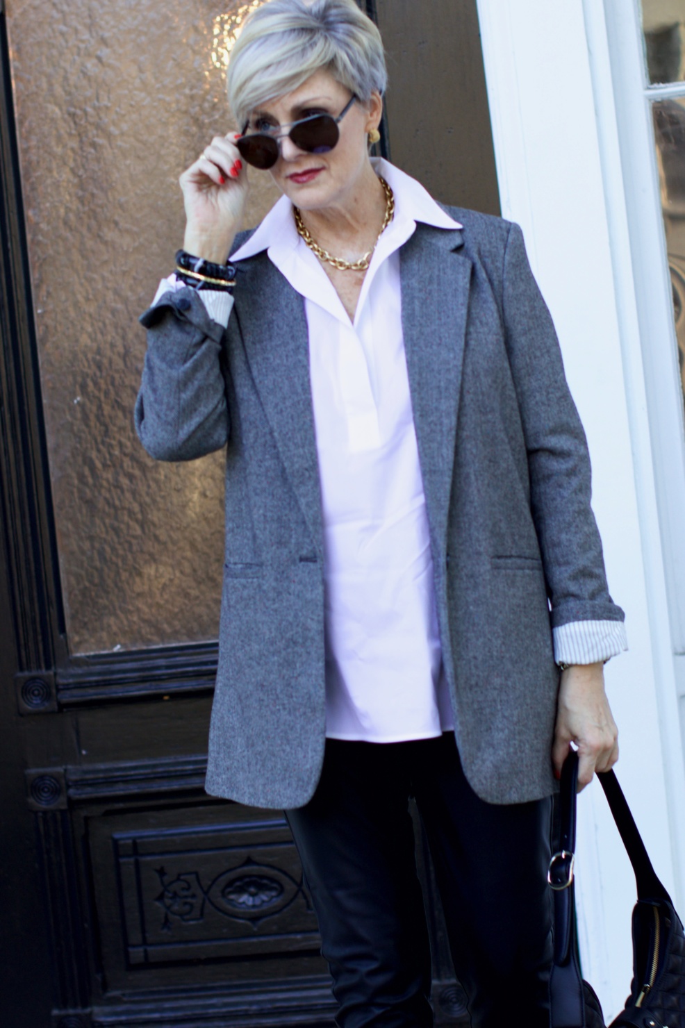 beth at Style at a Certain Age wears faux leather leggings, white shirt, boyfriend blazer, and black booties