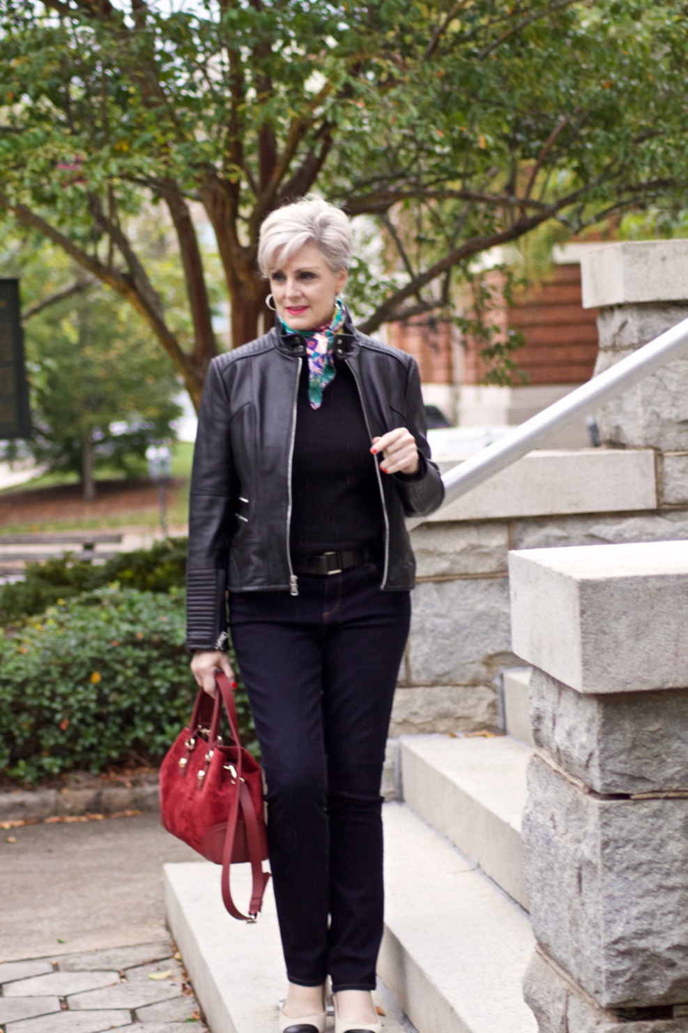 leather moto jacket, black sweater, silk scarf, statement handbag