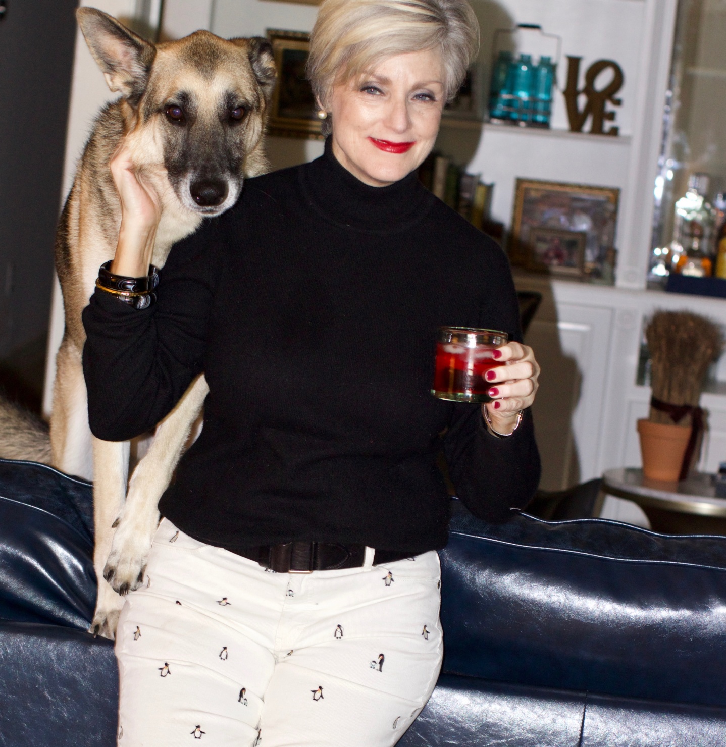 beth from Style at a Certain Age wears a black cashmere turtleneck, embroidered corduroys, and knit blazer