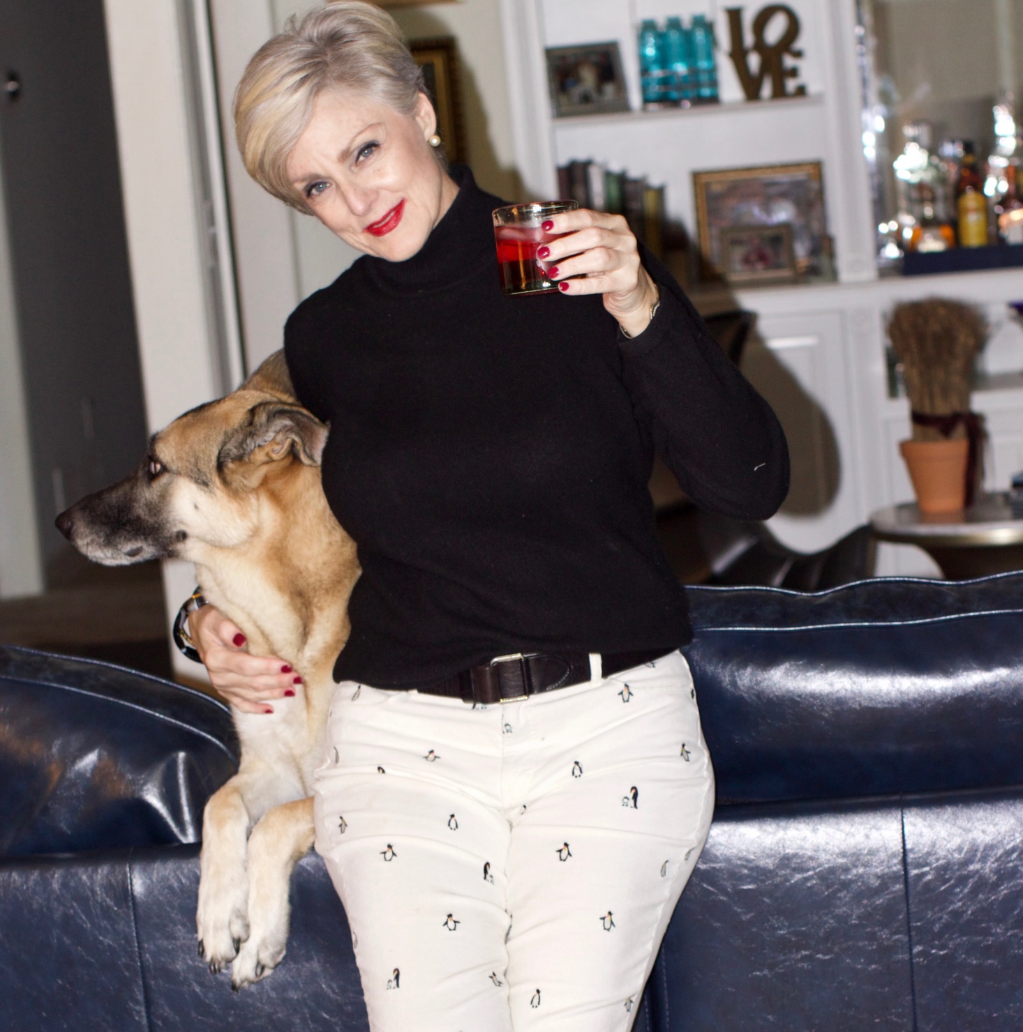 beth from Style at a Certain Age wears a black cashmere turtleneck, embroidered corduroys, and knit blazer