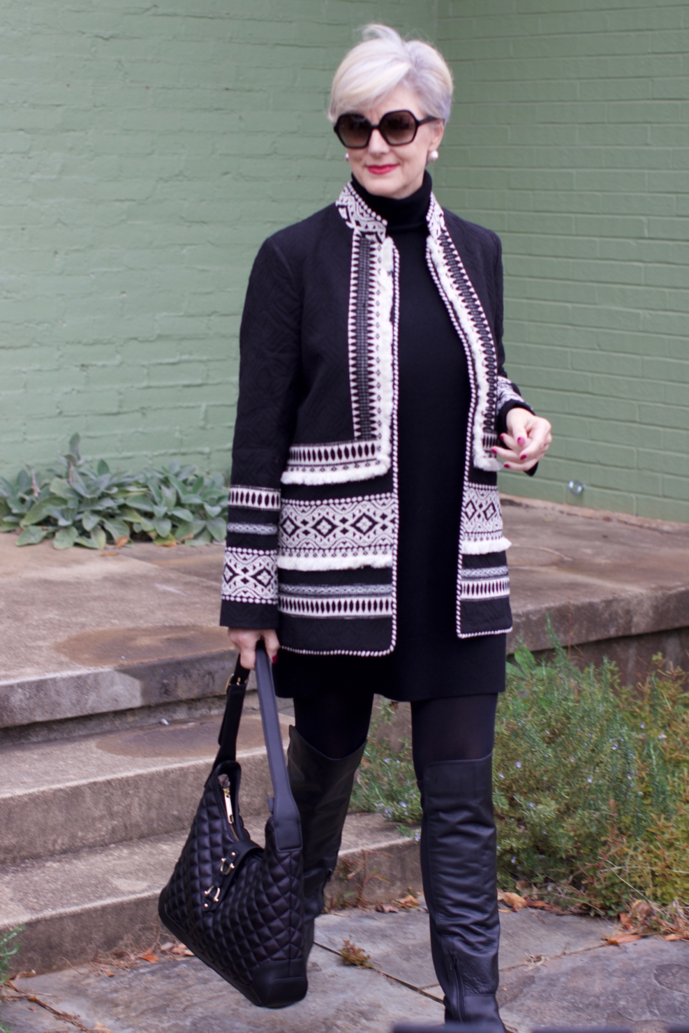 beth from style at a certain age wears a cashmere sweater dress from everlane, anthropologie embroidered jacket, black over the knee boots