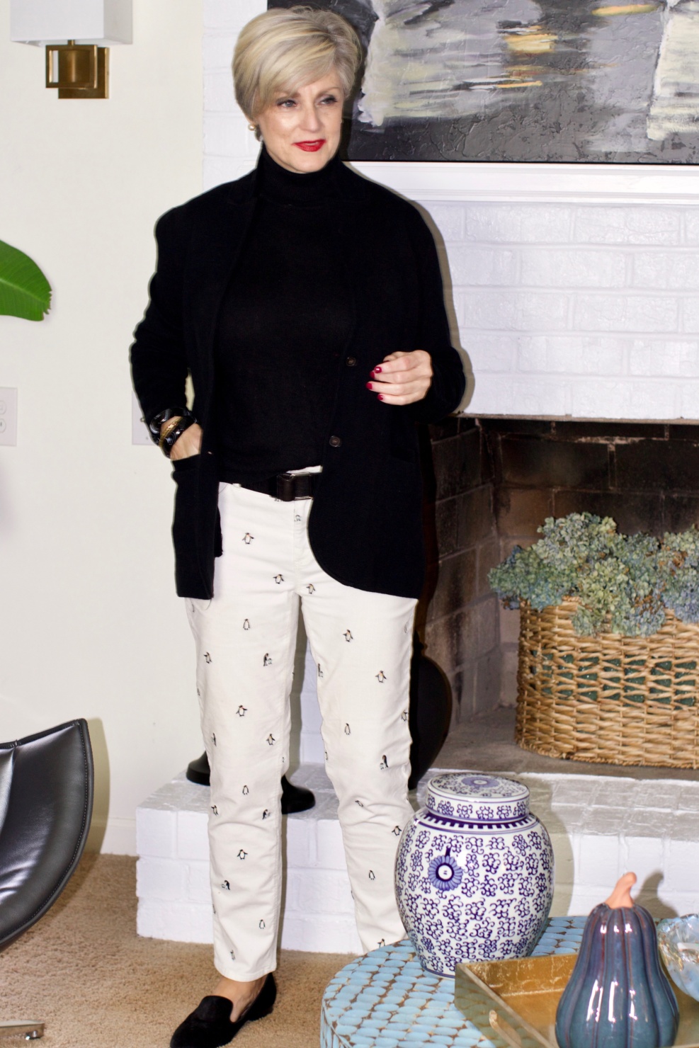 beth from Style at a Certain Age wears a black cashmere turtleneck, embroidered corduroys, and knit blazer