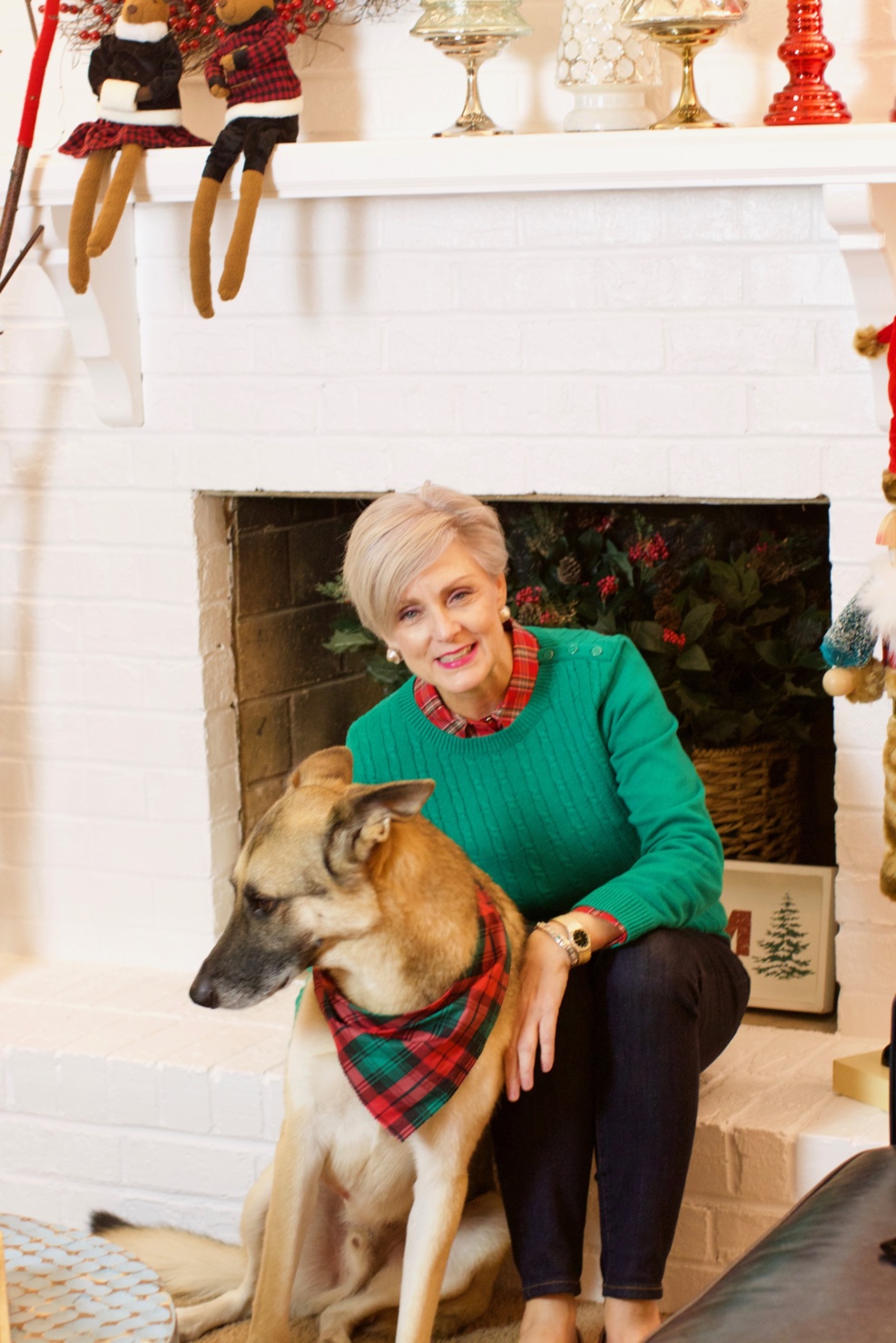 beth from Style at a Certain Age wears a cable knit sweater and plaid shirt dark rinse blue jeans