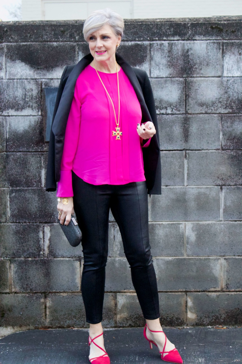 beth from style at a certain age wears a pink silk top from J.Crew, faux leather leggings from Ann Taylor, and a black tuxedo blazer