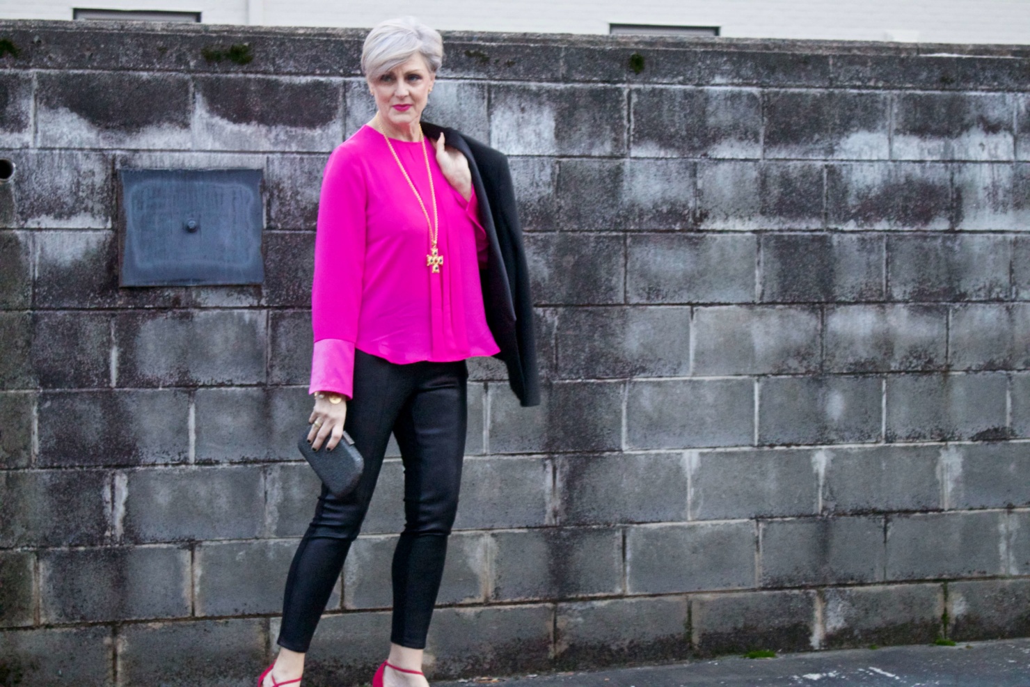 beth from style at a certain age wears a pink silk top from J.Crew, faux leather leggings from Ann Taylor, and a black tuxedo blazer