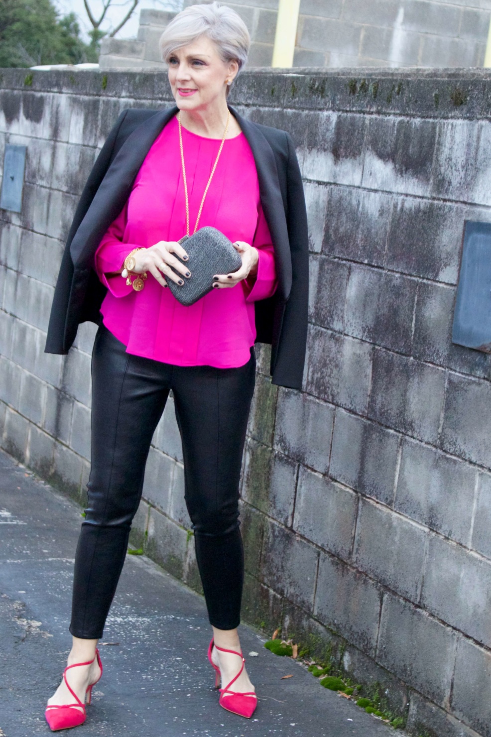 beth from style at a certain age wears a pink silk top from J.Crew, faux leather leggings from Ann Taylor, and a black tuxedo blazer