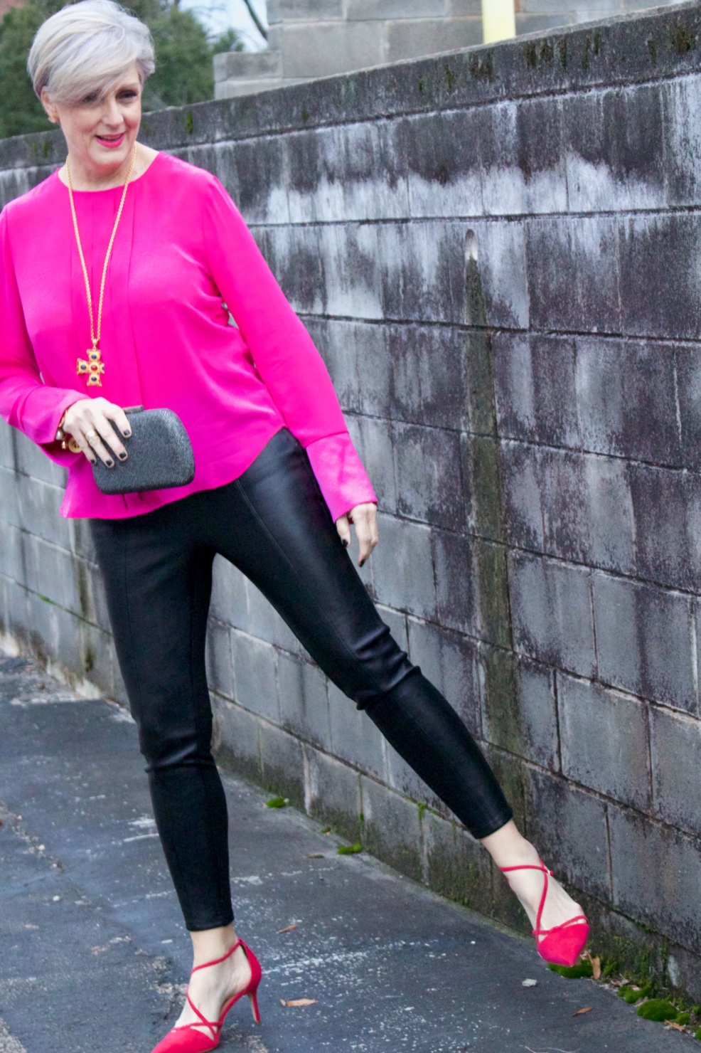 beth from style at a certain age wears a pink silk top from J.Crew, faux leather leggings from Ann Taylor, and a black tuxedo blazer