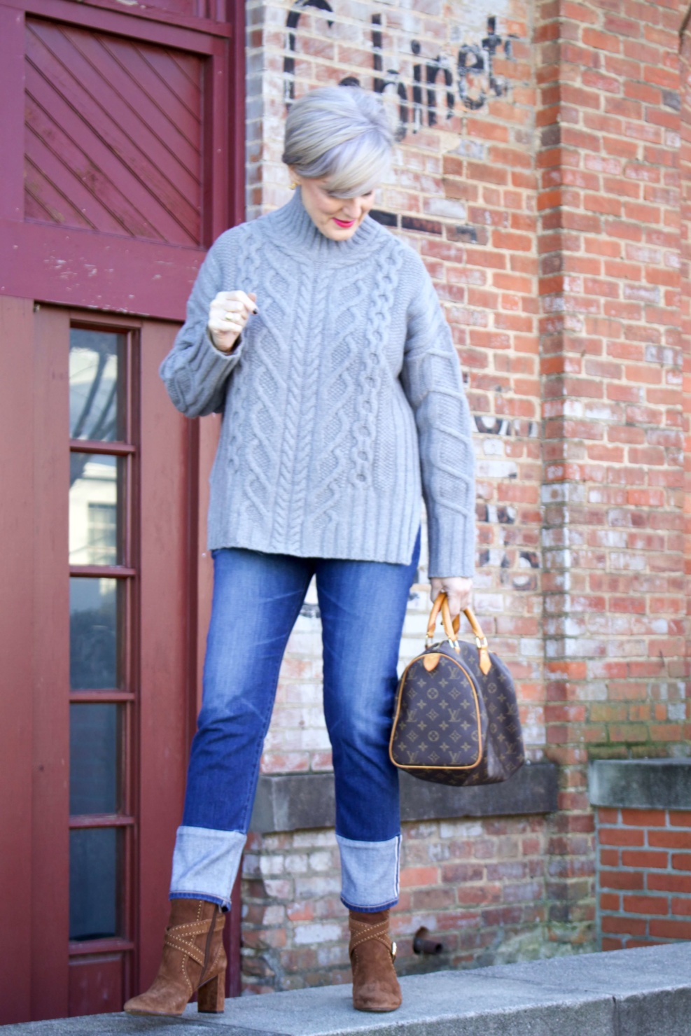 warm cozy sweater. beth from Style at a Certain Age wears cuffed blue jeans, cable knit sweater, and suede boots.