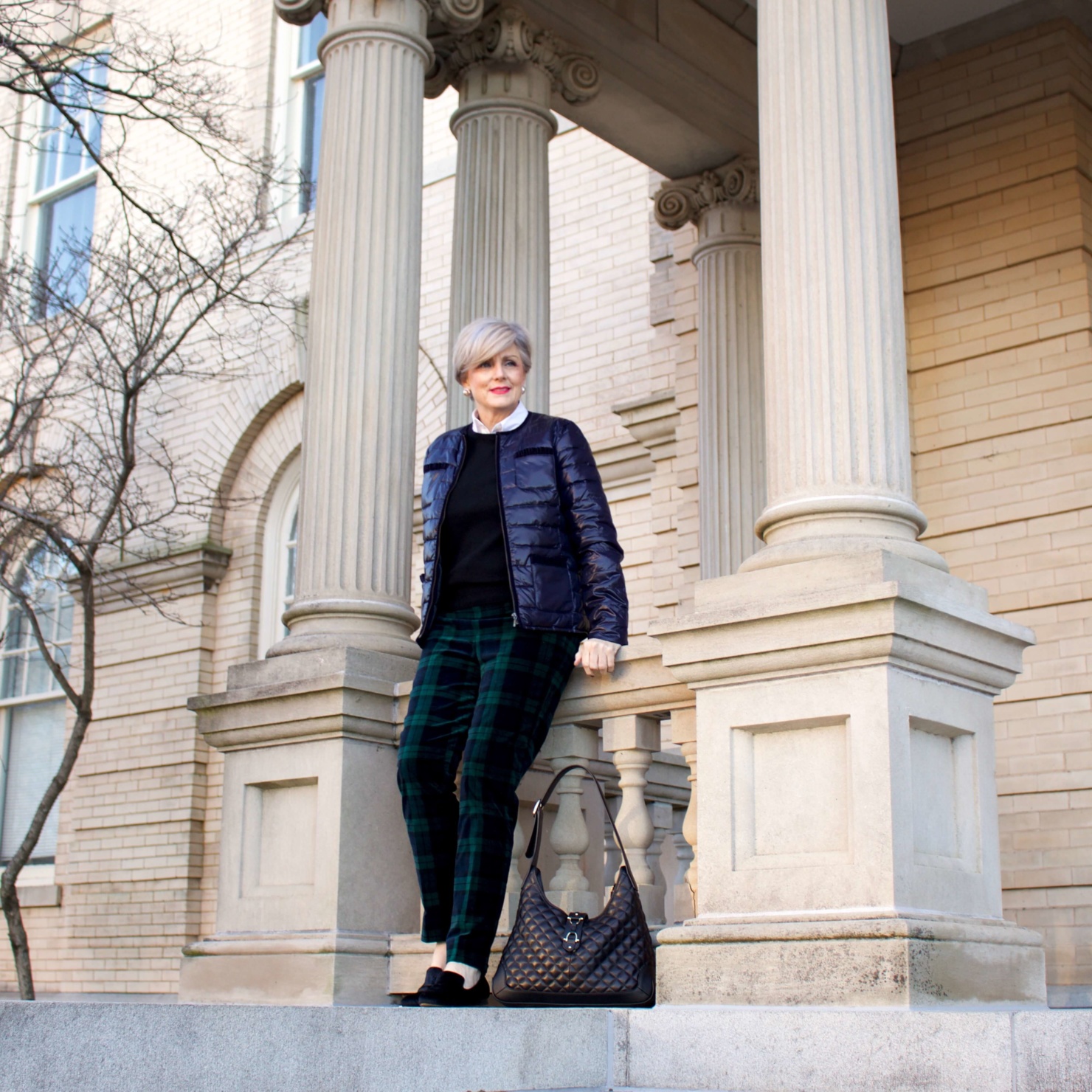 Christmas in the City - beth from Style at a Certain Age wears a Talbots navy puffer jacket, black watch plaid ankle pants and an Everlane black cashmere crewneck