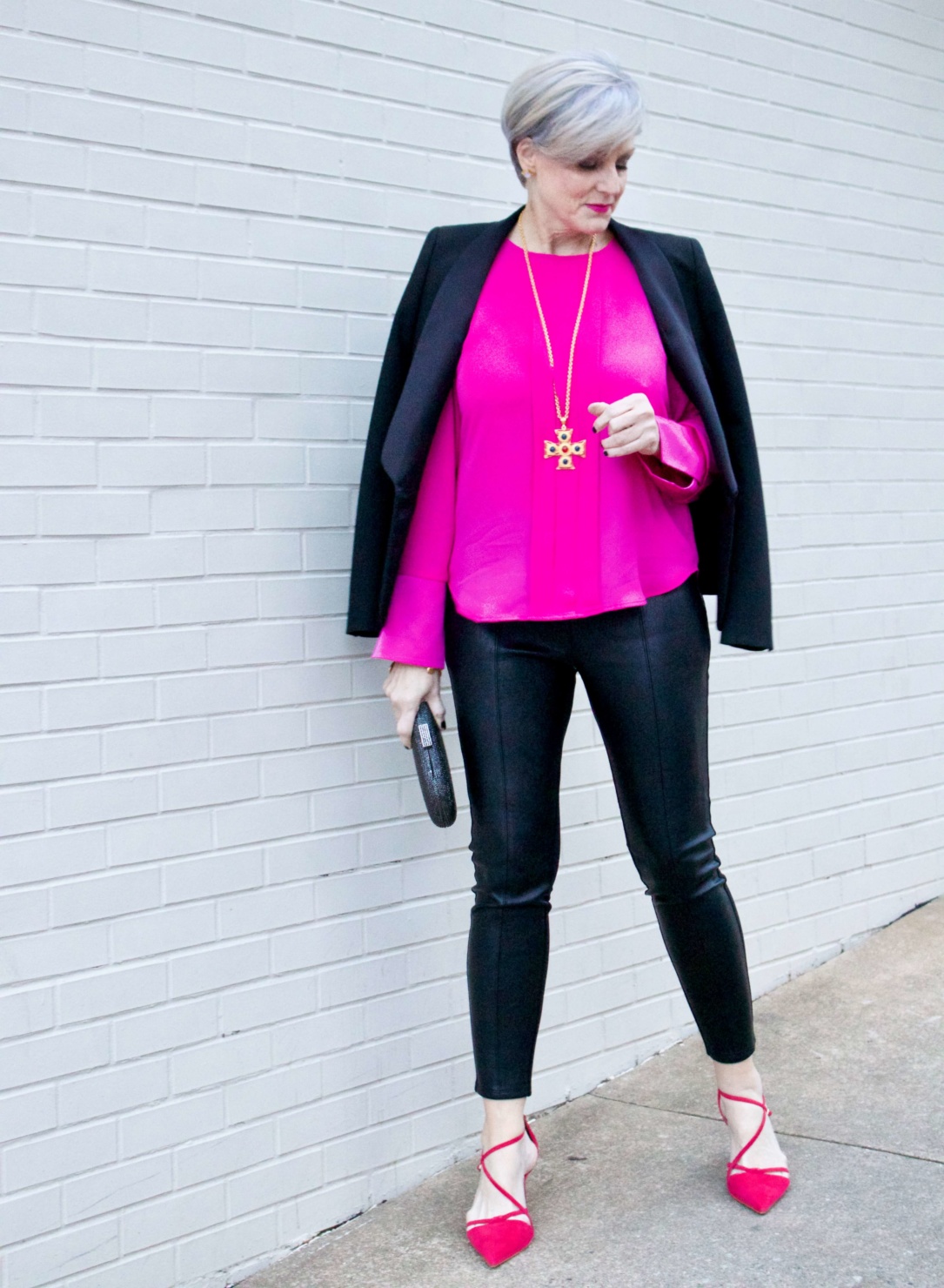 beth from style at a certain age wears a pink silk top from J.Crew, faux leather leggings from Ann Taylor, and a black tuxedo blazer