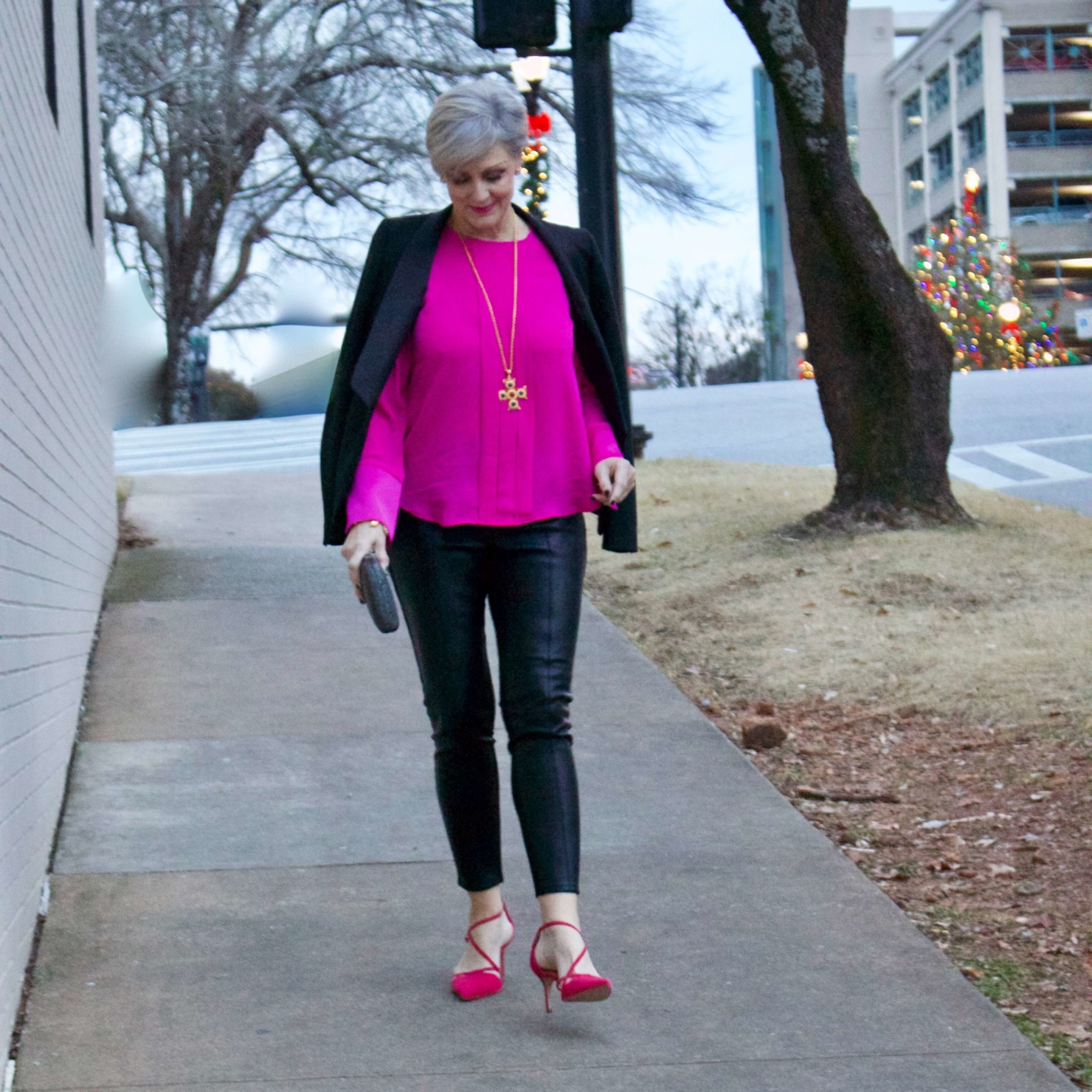 beth from style at a certain age wears a pink silk top from J.Crew, faux leather leggings from Ann Taylor, and a black tuxedo blazer