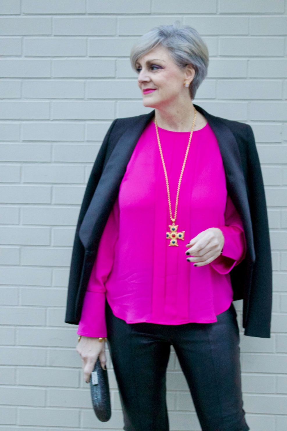 beth from style at a certain age wears a pink silk top from J.Crew, faux leather leggings from Ann Taylor, and a black tuxedo blazer