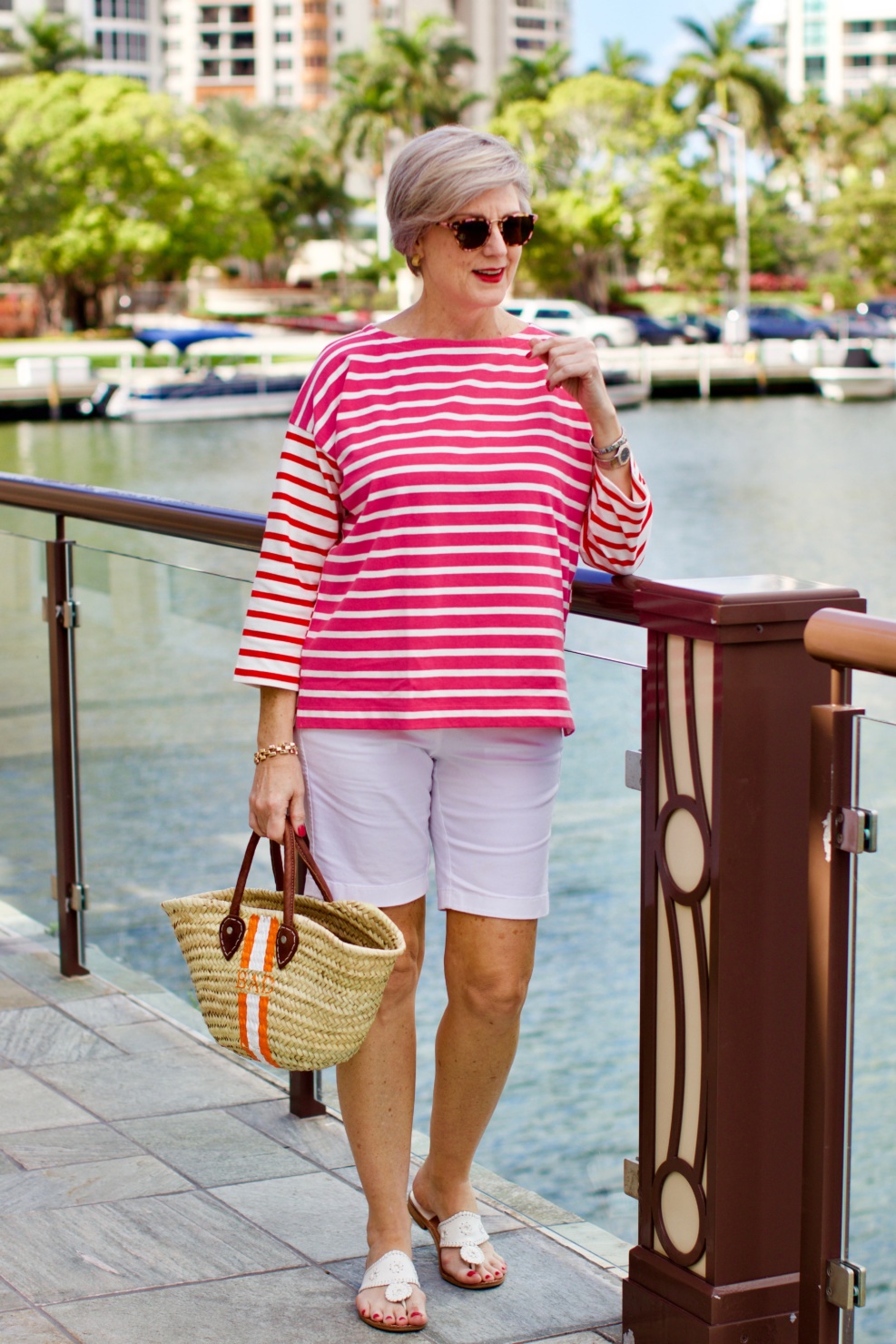 beth from Style at a Certain Age wears a J.Crew striped tee, white bermuda shorts, and Jack Rogers sandals