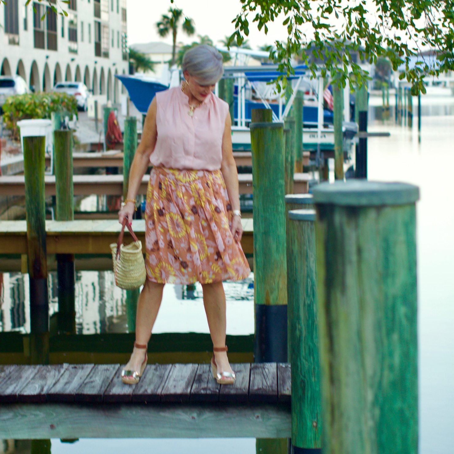 beth from Style at a Certain Age wears a Tory Burch silk blow blouse, silk skirt, and Tory Burch wedges