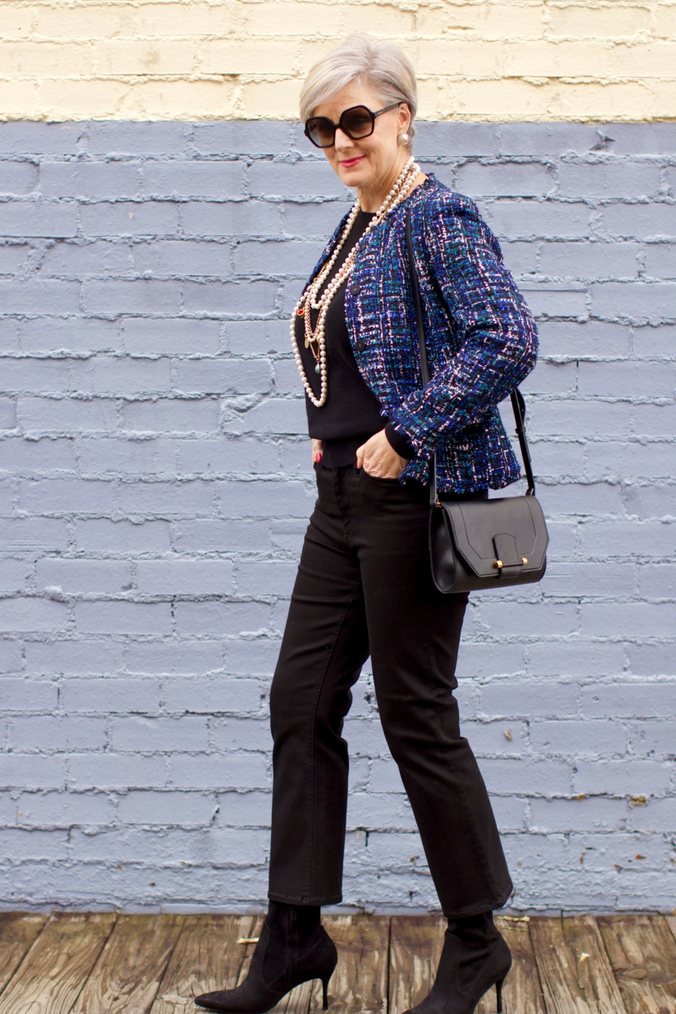 beth at Style at a Certain Age wears an Ann Taylor tweed military jacket, Everlane crewneck cashmere, J.Crew cropped flare denim, pointy-toed boots and strings of pearls