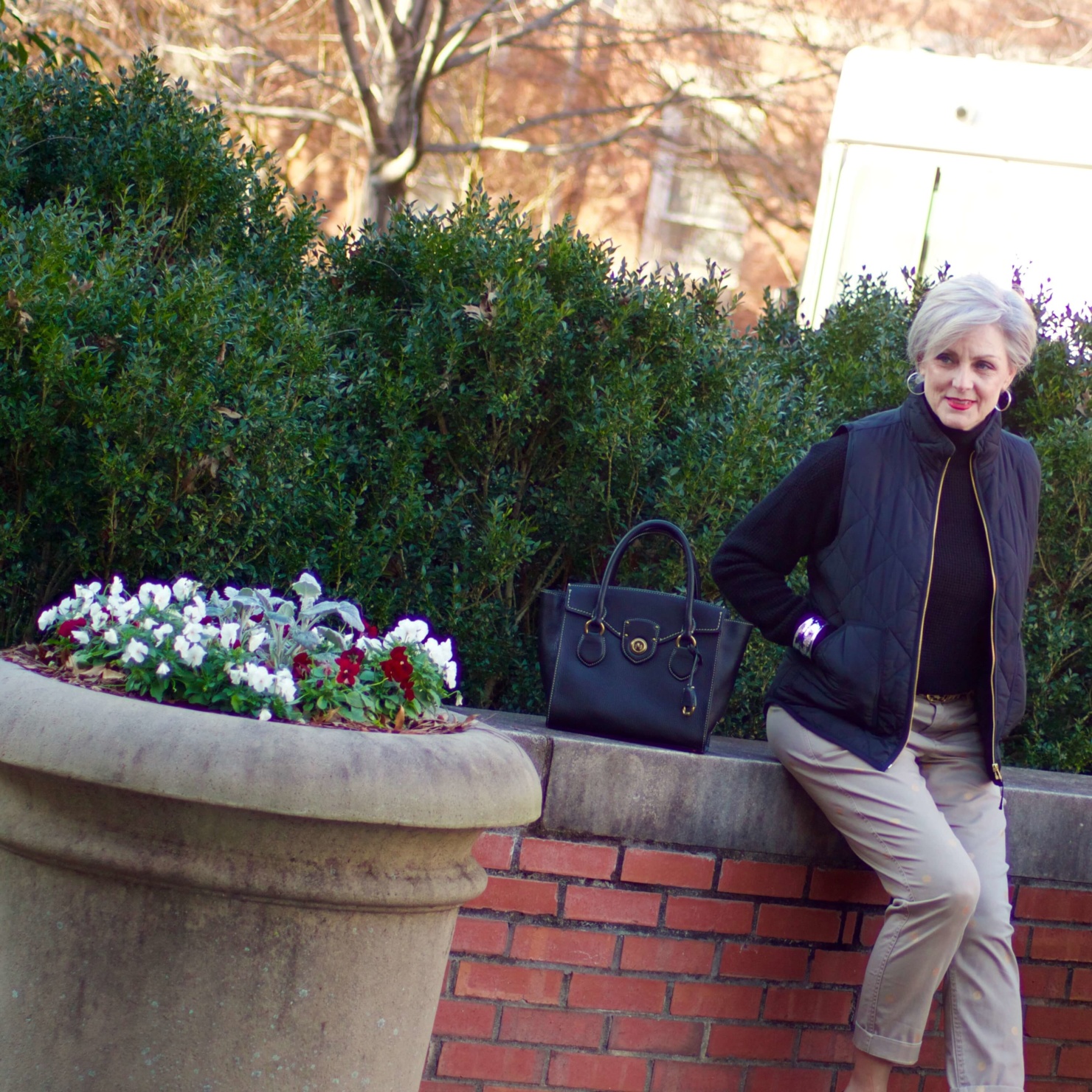 beth from Style at a Certain Age wears J.Crew polka dot chinos, Everlane cashmere waffle turtleneck, J.Crew Factory puffer vest, and Ann Taylor leopard flats