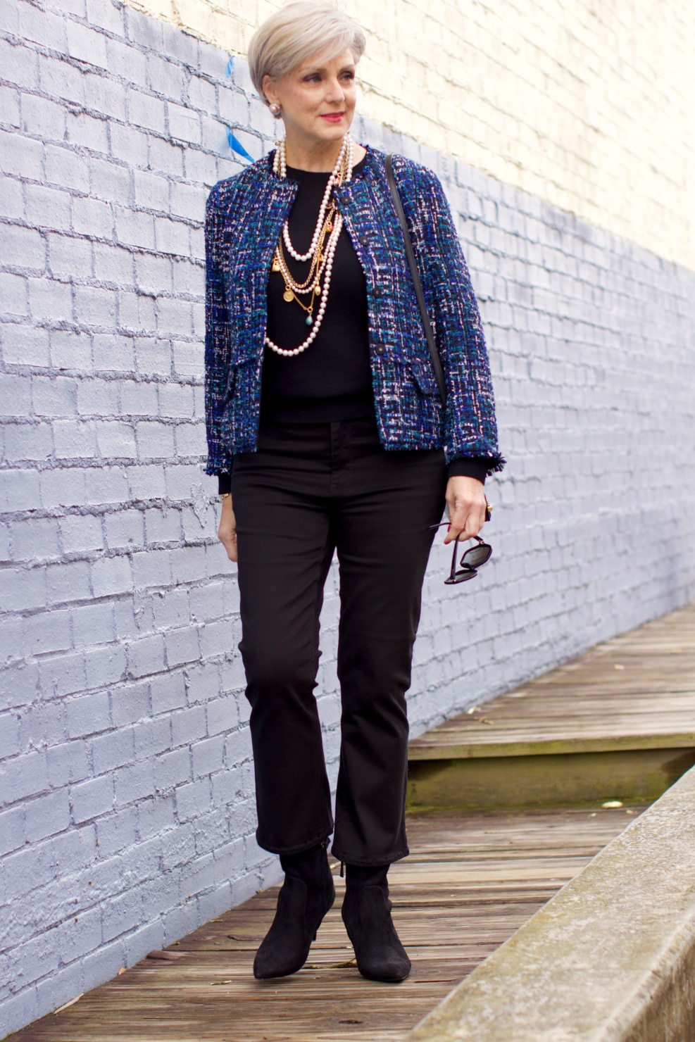 beth at Style at a Certain Age wears an Ann Taylor tweed military jacket, Everlane crewneck cashmere, J.Crew cropped flare denim, pointy-toed boots and strings of pearls