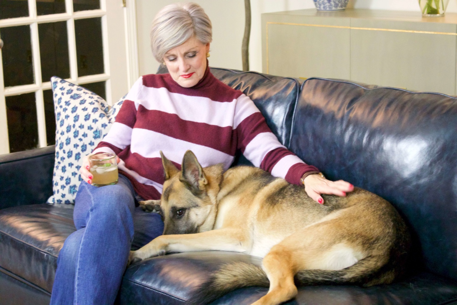 beth from Style at a Certain Age wears a striped turtleneck, J.Crew denim, and Cole Haan suede oxfords