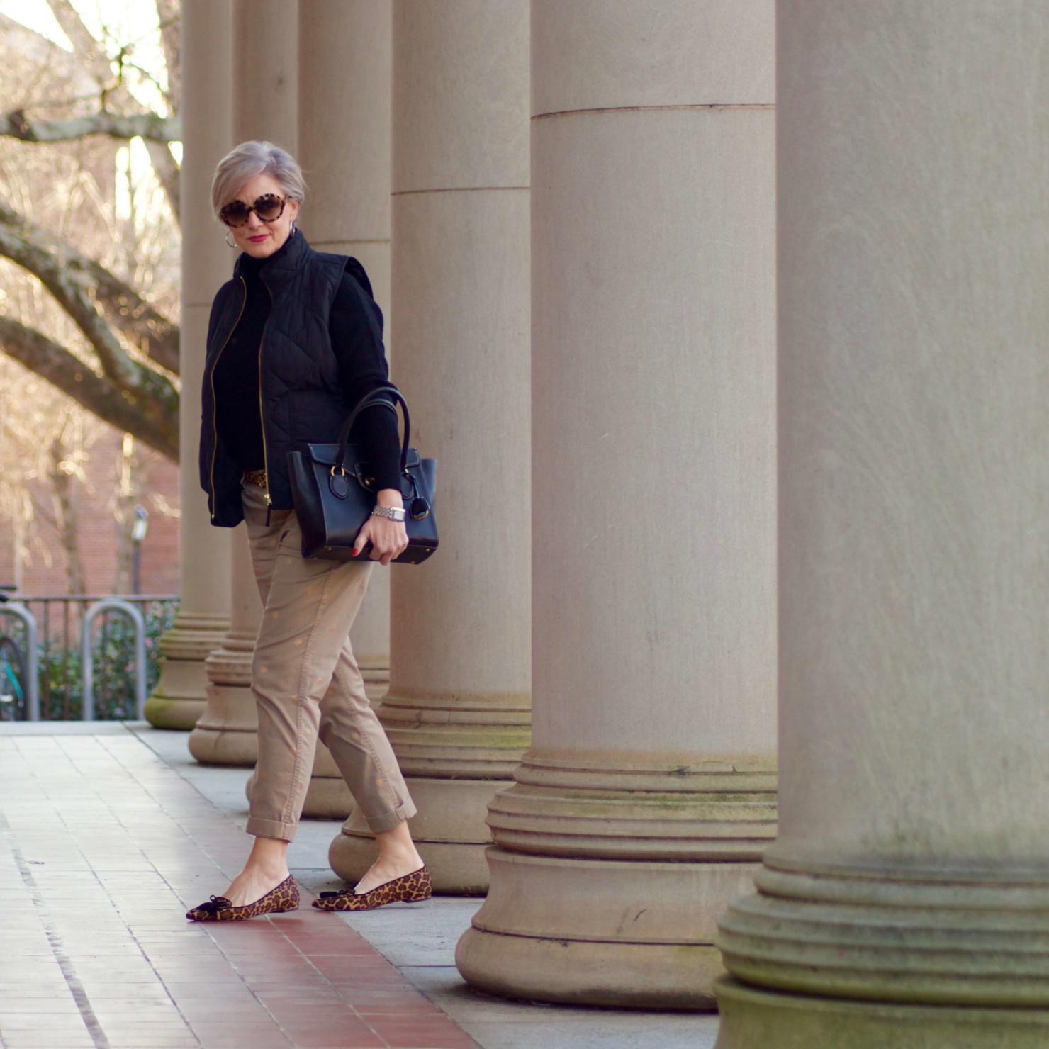 beth from Style at a Certain Age wears J.Crew polka dot chinos, Everlane cashmere waffle turtleneck, J.Crew Factory puffer vest, and Ann Taylor leopard flats