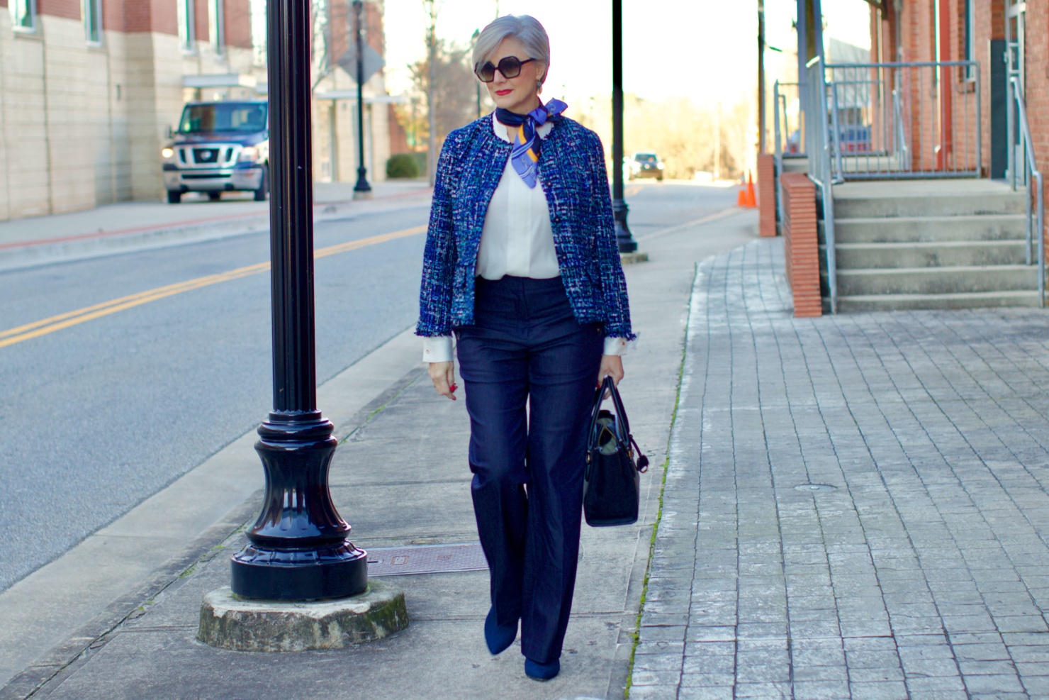 beth from Style at a Certain Age wears an Ann Taylor blue tweed jacket, faux denim sailor pants, v neck button sleeve blouse, silk ribbon chain scarf, and pointy toe booties