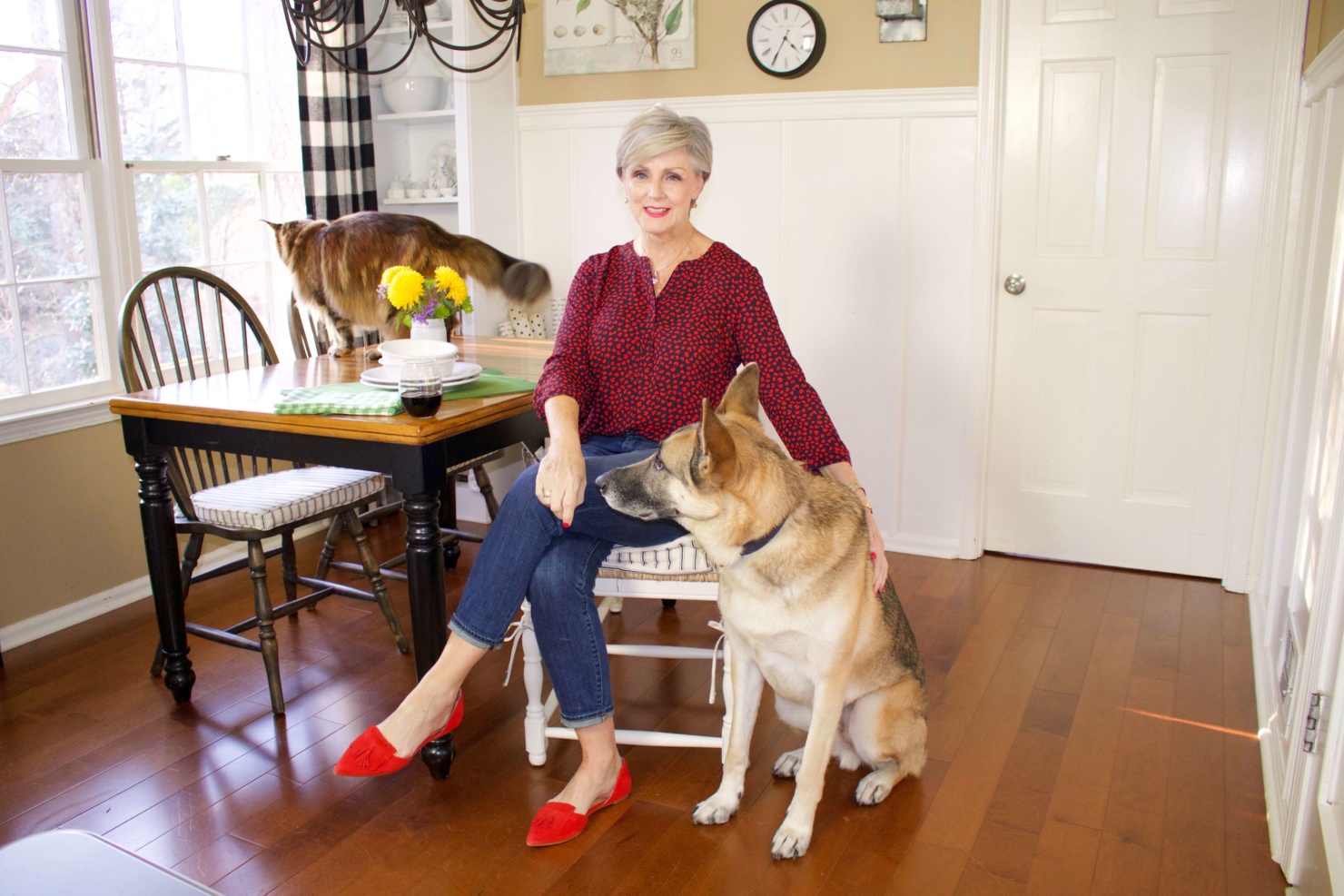 beth from Style at a Certain Age wears a Talbots red heart blouse, girlfriend jeans, and red shoes