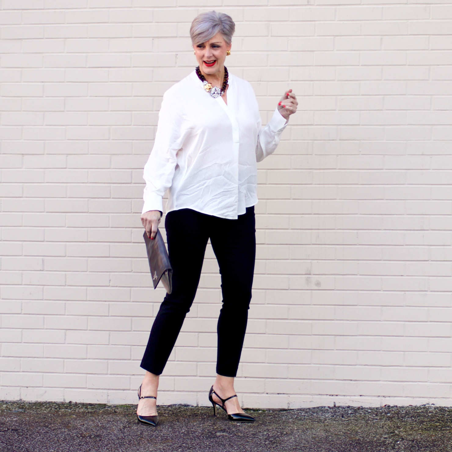 beth from Style at a Certain Age wears an ivory Vince jacquard silk blouse, Everlance slim wool pant, and SJP mary jane patent leather shoes