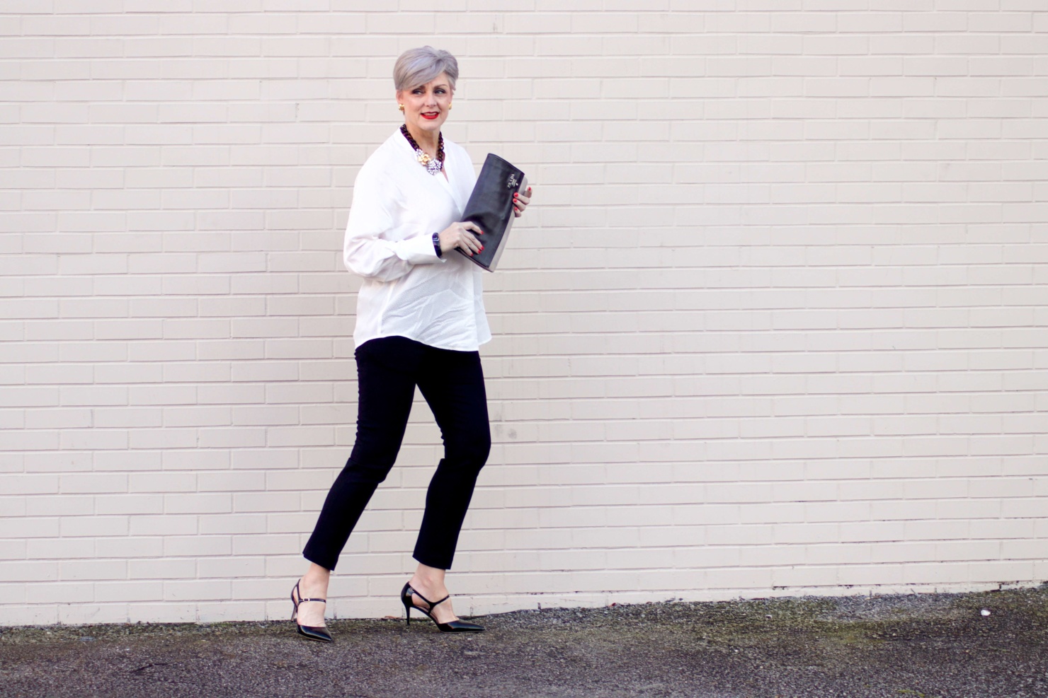 beth from Style at a Certain Age wears an ivory Vince jacquard silk blouse, Everlance slim wool pant, and SJP mary jane patent leather shoes