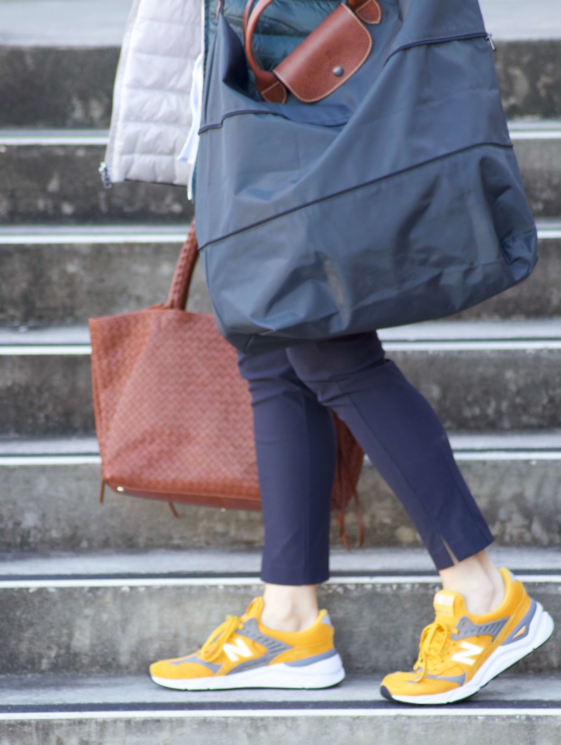 beth from Style at a Certain Age wears Athleta pants, white shirt, puffer jacket, and sneakers