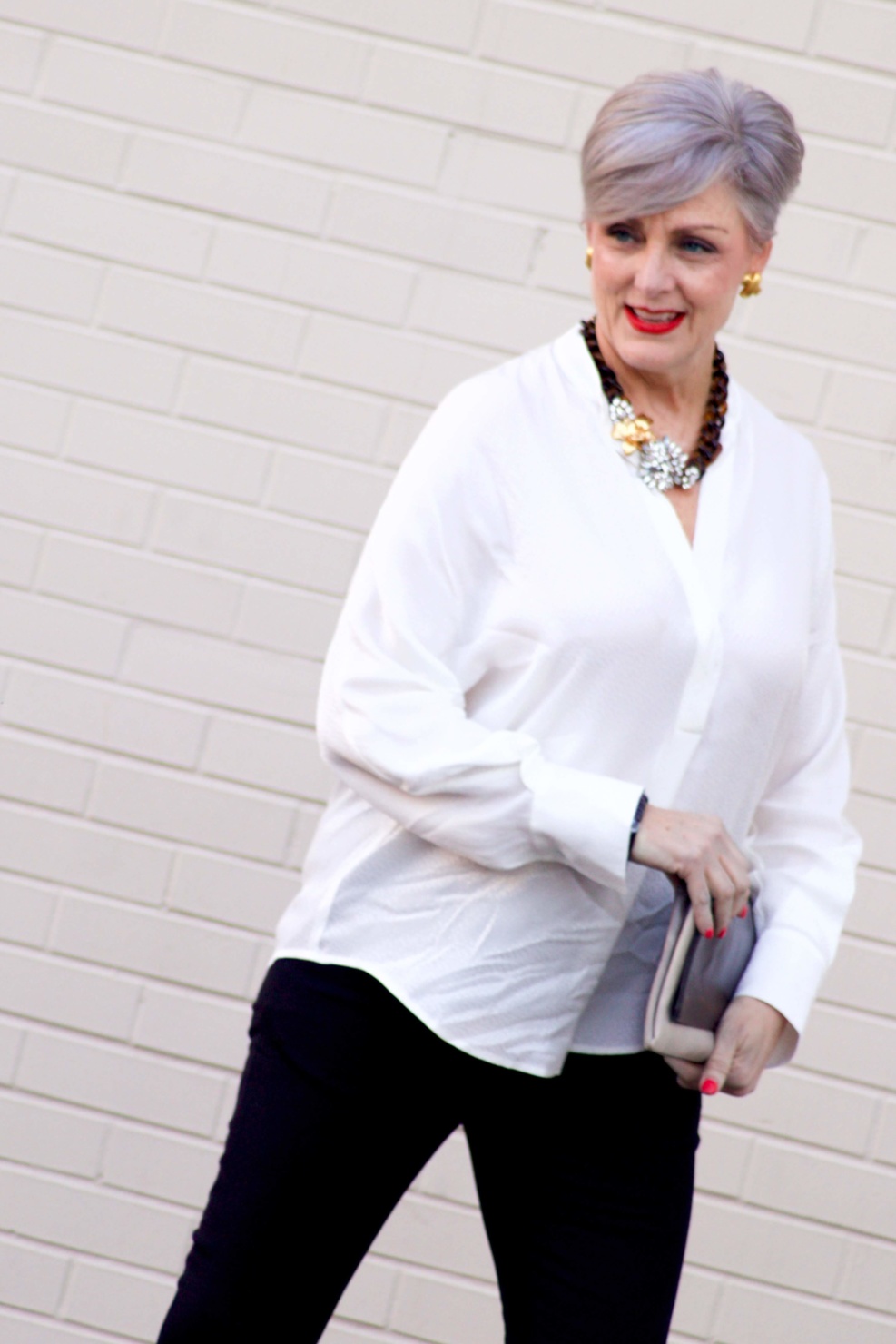 beth from Style at a Certain Age wears an ivory Vince jacquard silk blouse, Everlance slim wool pant, and SJP mary jane patent leather shoes