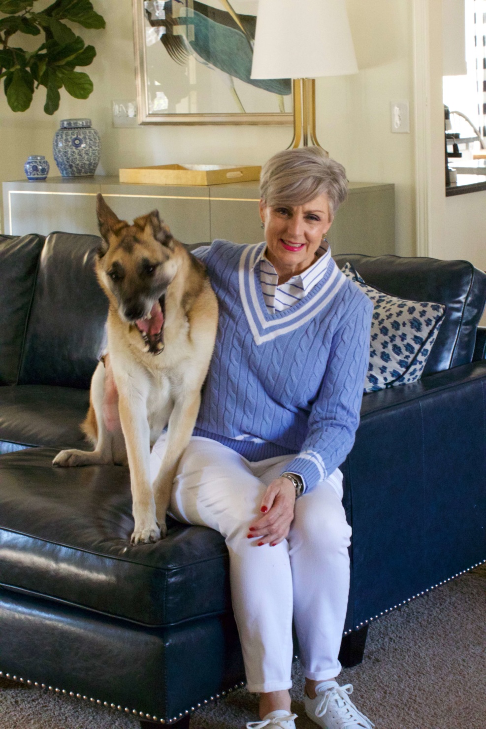 beth from Style at a Certain Age wears a Ralph Lauren cricket sweater, white denim and white tennis shoes