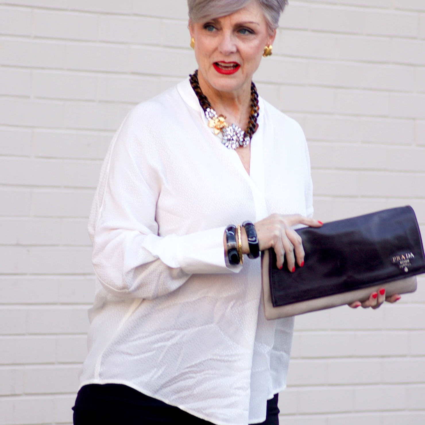 beth from Style at a Certain Age wears an ivory Vince jacquard silk blouse, Everlance slim wool pant, and SJP mary jane patent leather shoes