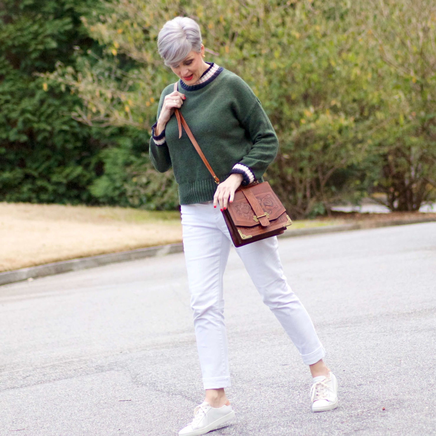 beth from Style at a Certain Age wears a Boden green sweater, white denim and white sneakers