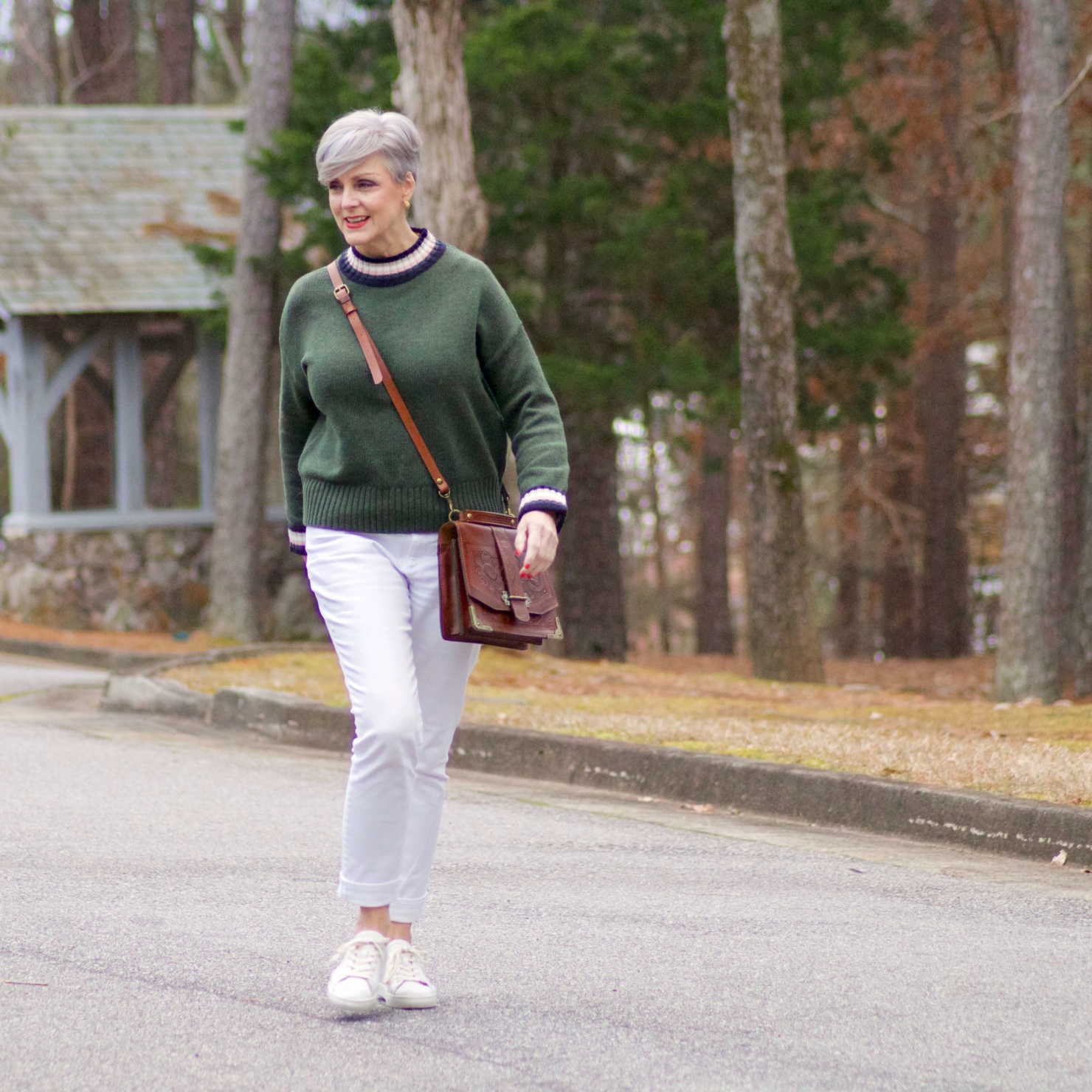 beth from Style at a Certain Age wears a Boden green sweater, white denim and white sneakers