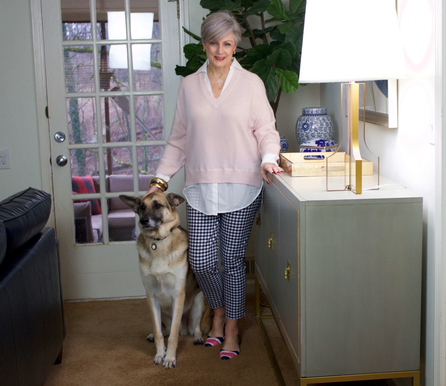 beth from Style at a Certain Age wears a paloma pink sweater with white underlay, gingham pants, and pointy toe flats