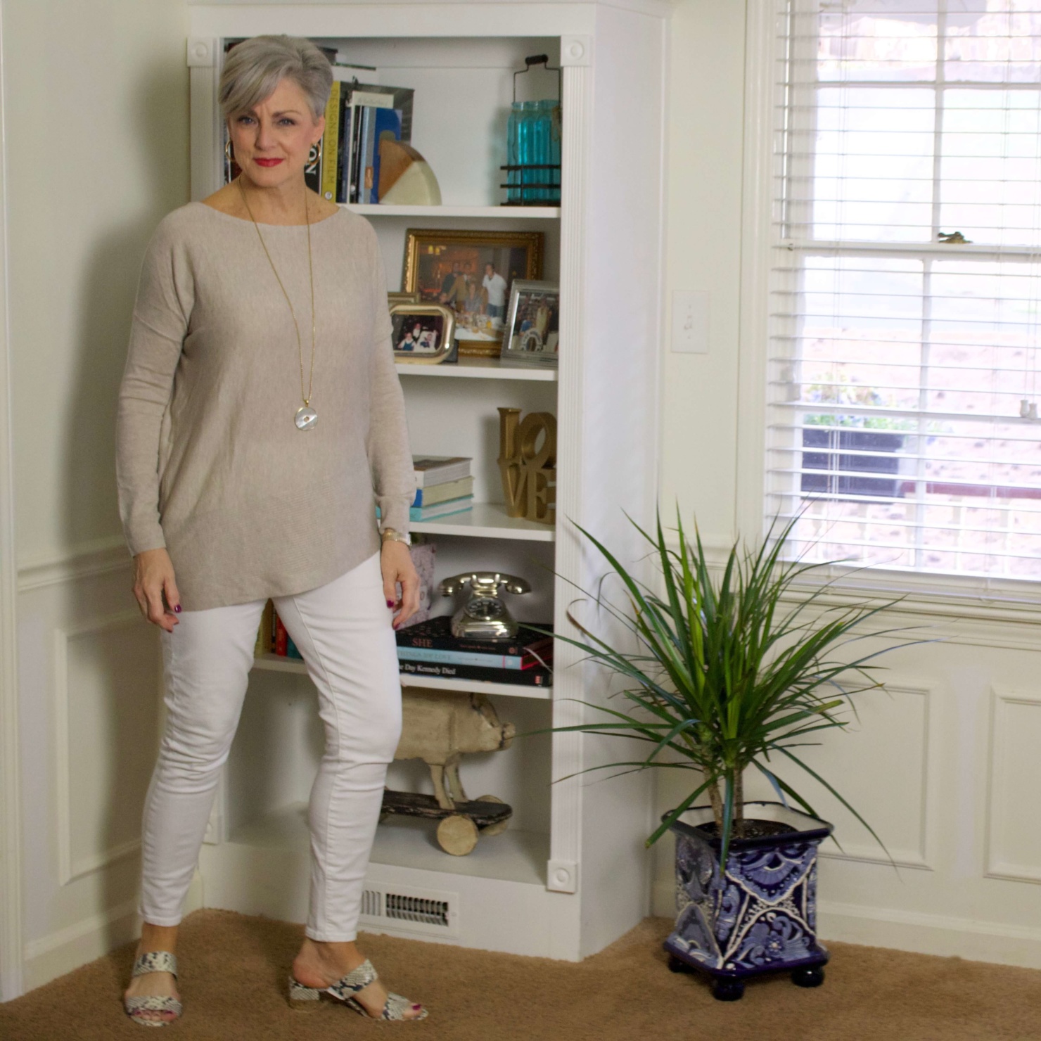 beth from Style at a Certain Age wears spring neutrals, white denim, asymmetrical tunic, snakeskin sandals