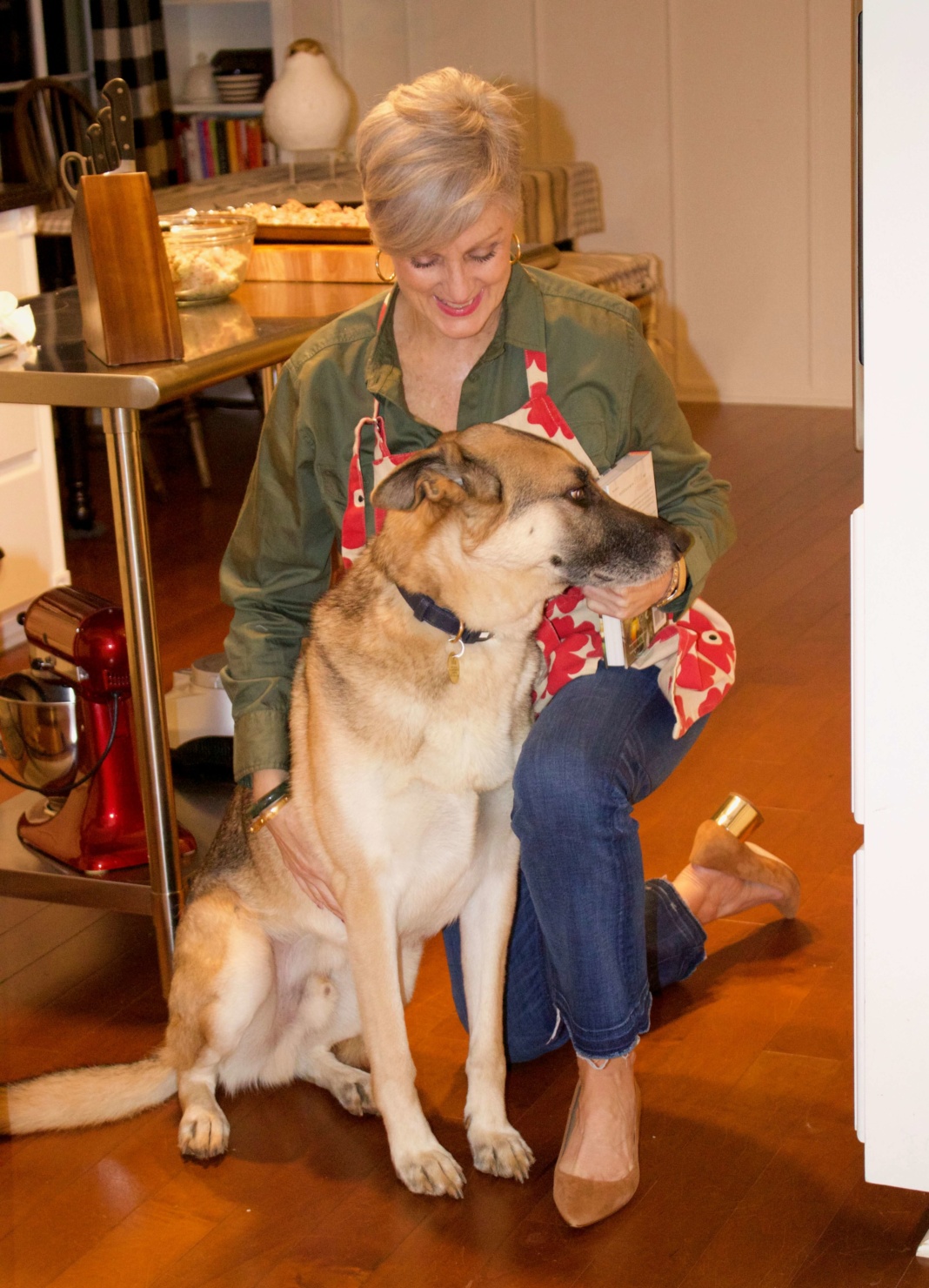 beth from Style at a Certain Age wears a green utility shirt, frayed denim, and suede block heel shoes