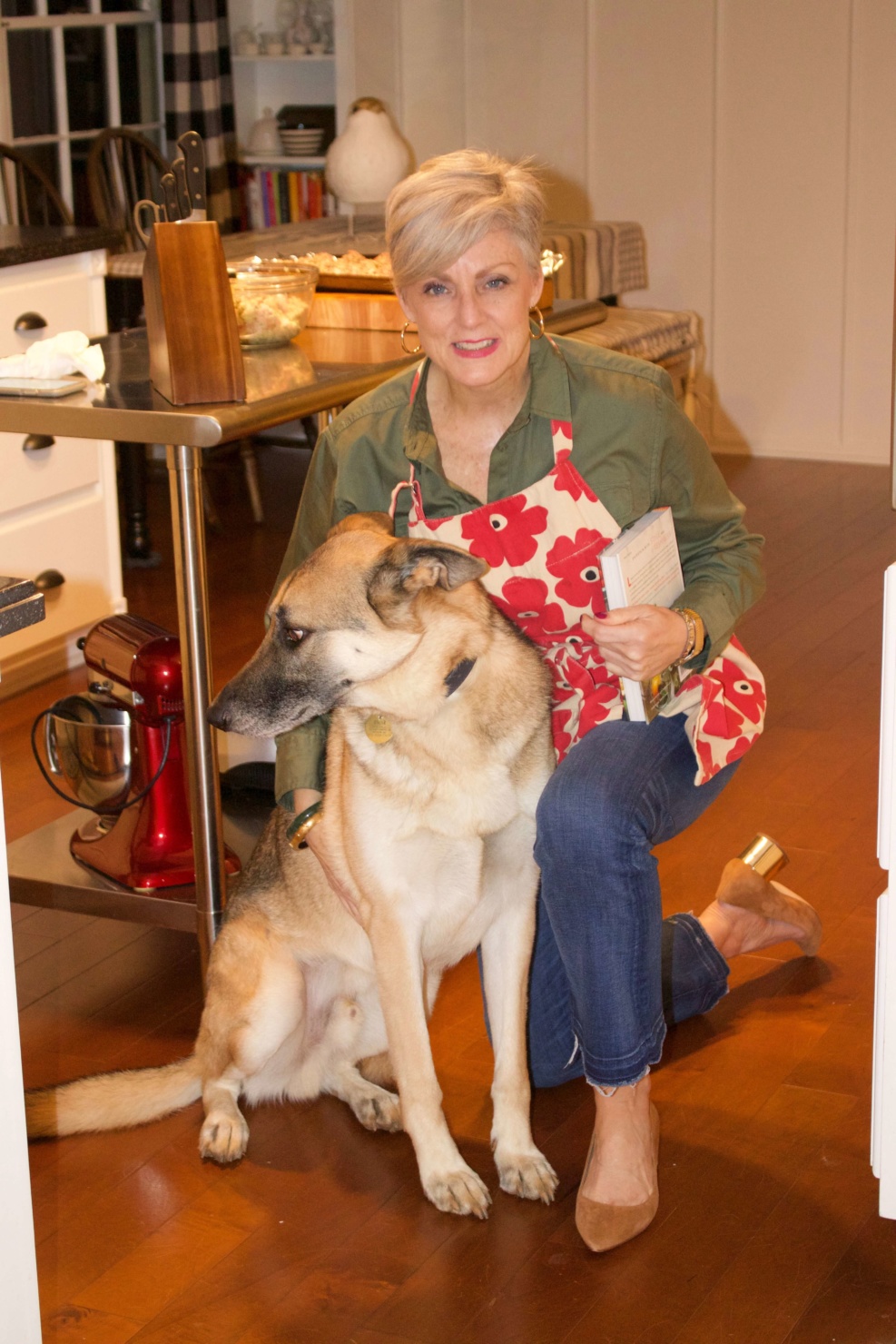 beth from Style at a Certain Age wears a green utility shirt, frayed denim, and suede block heel shoes