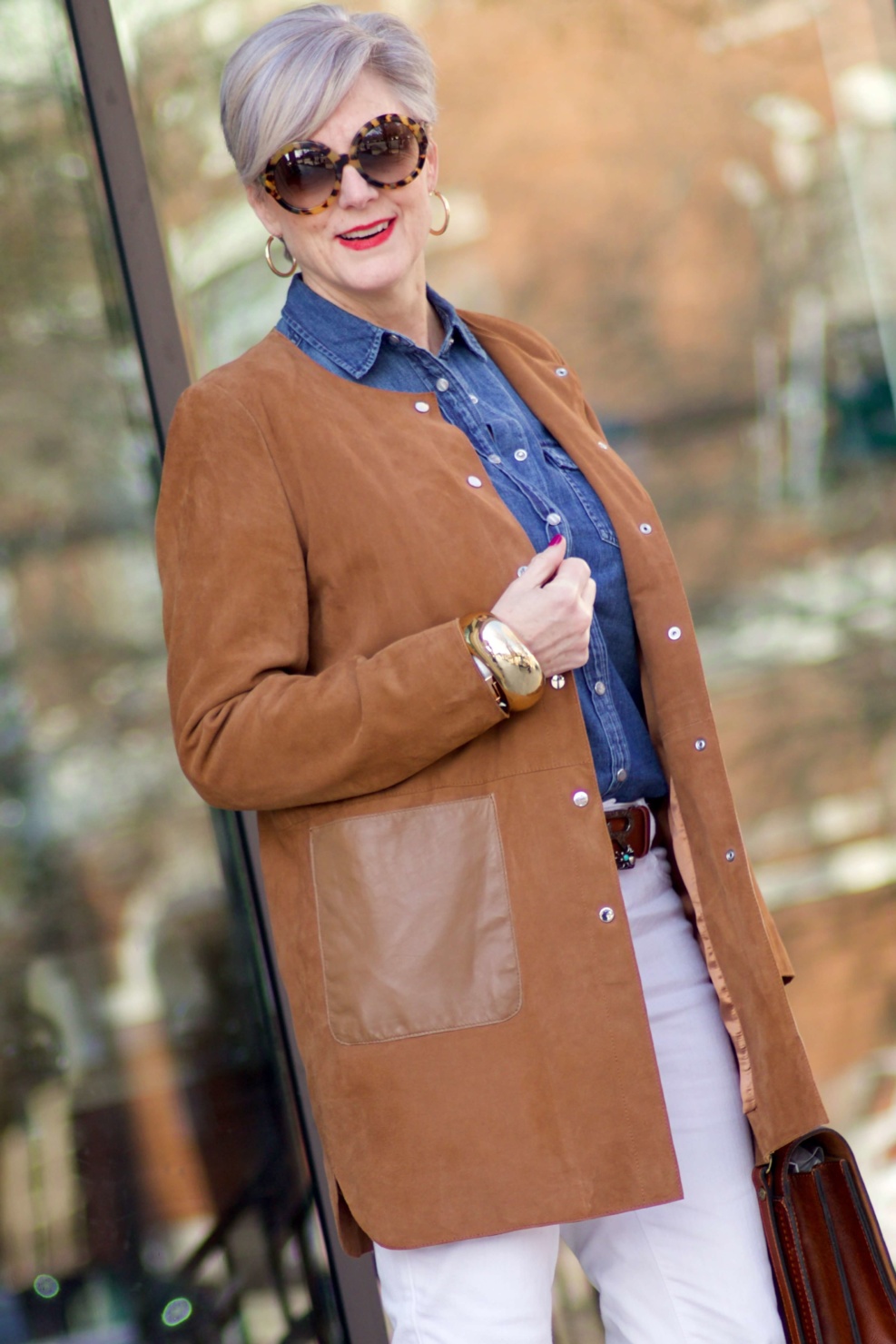 beth from Style at a Certain Age wears white denim, chambray shirt, suede jacket and booties