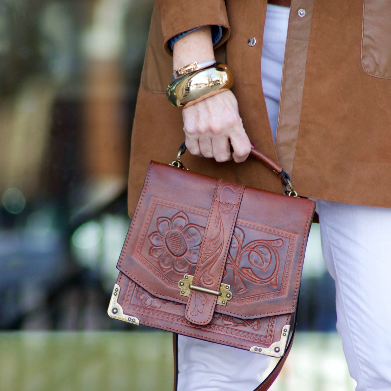 beth from Style at a Certain Age wears white denim, chambray shirt, suede jacket and booties