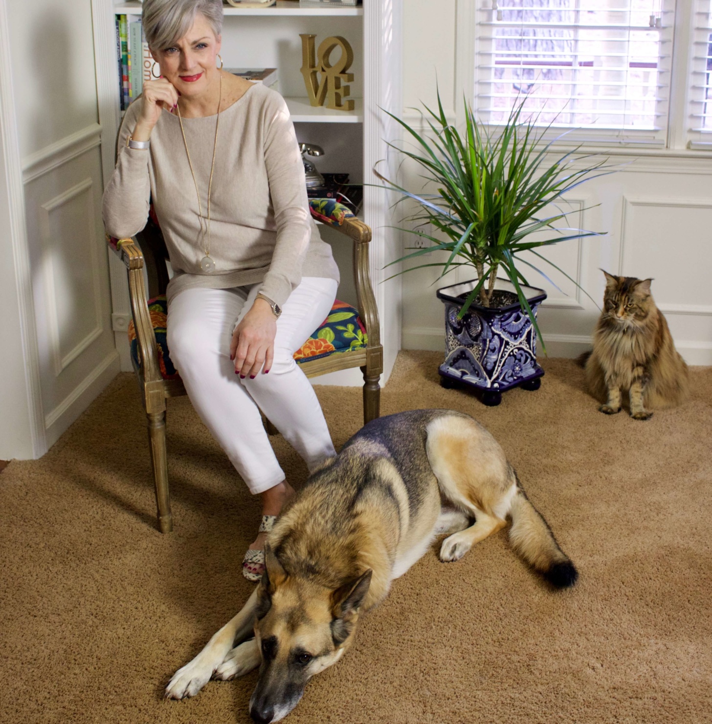 beth from Style at a Certain Age wears spring neutrals, white denim, asymmetrical tunic, snakeskin sandals