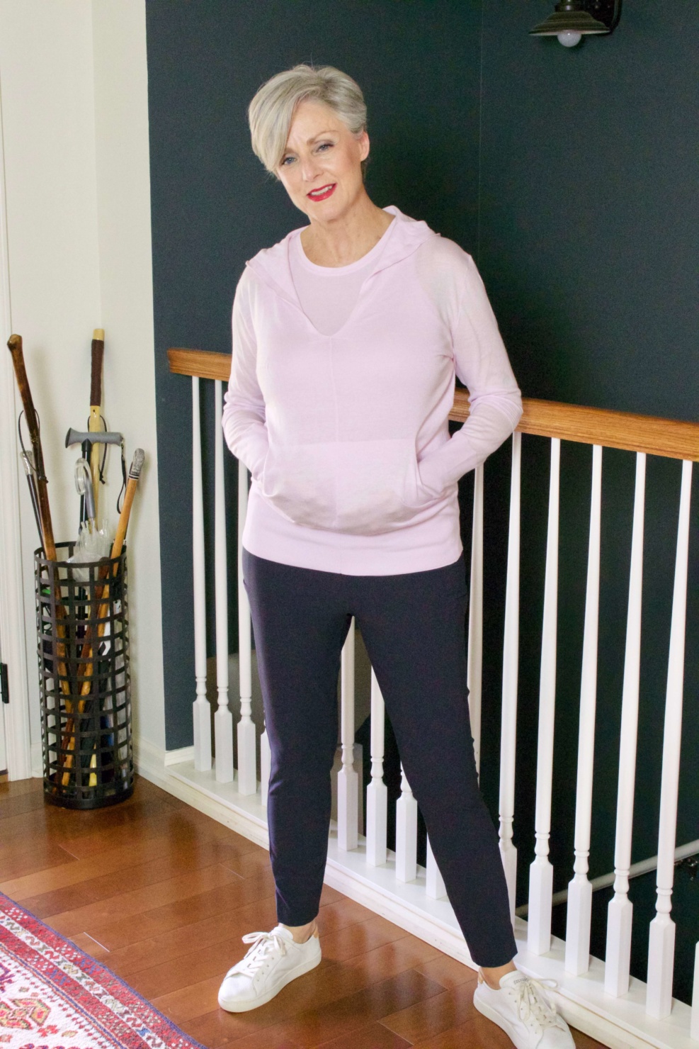 beth from Style at a Certain Age wears travel style Athleta wander slim pants, essence vital tank, and enlighten sweater hoodie