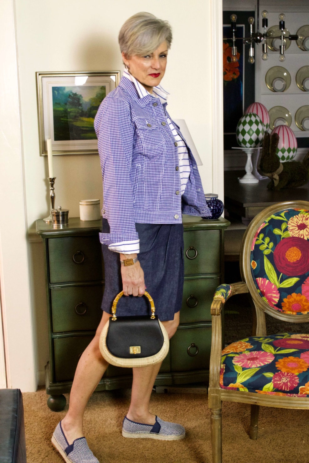 beth from Style at a Certain Age wears a gingham jean jacket, striped shirt, denim skirt, espadrilles and wicker handbag