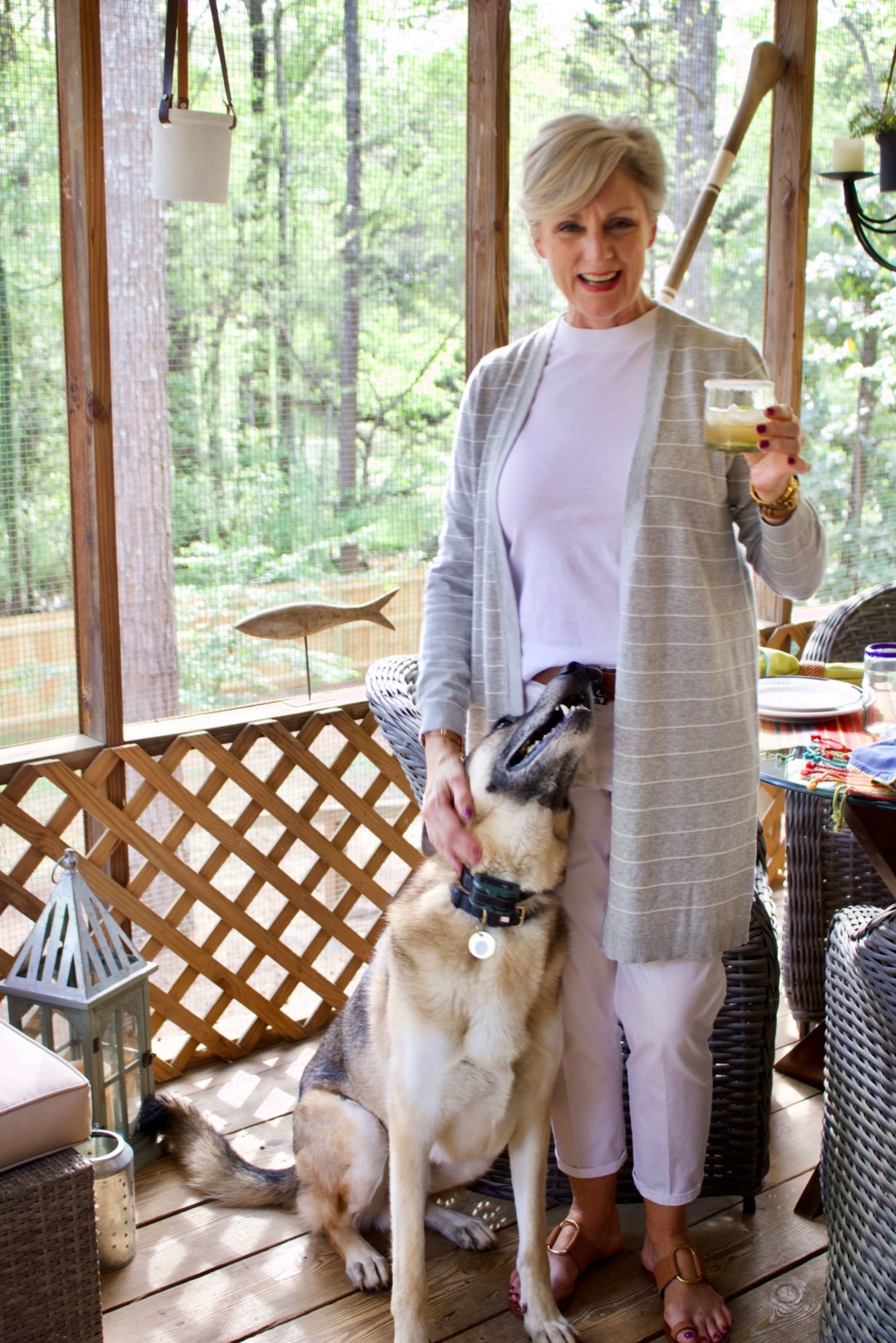 beth from Style at a Certain Age wears white girlfriend chinos, white muscle tee, gray cardigan, and brown sandals