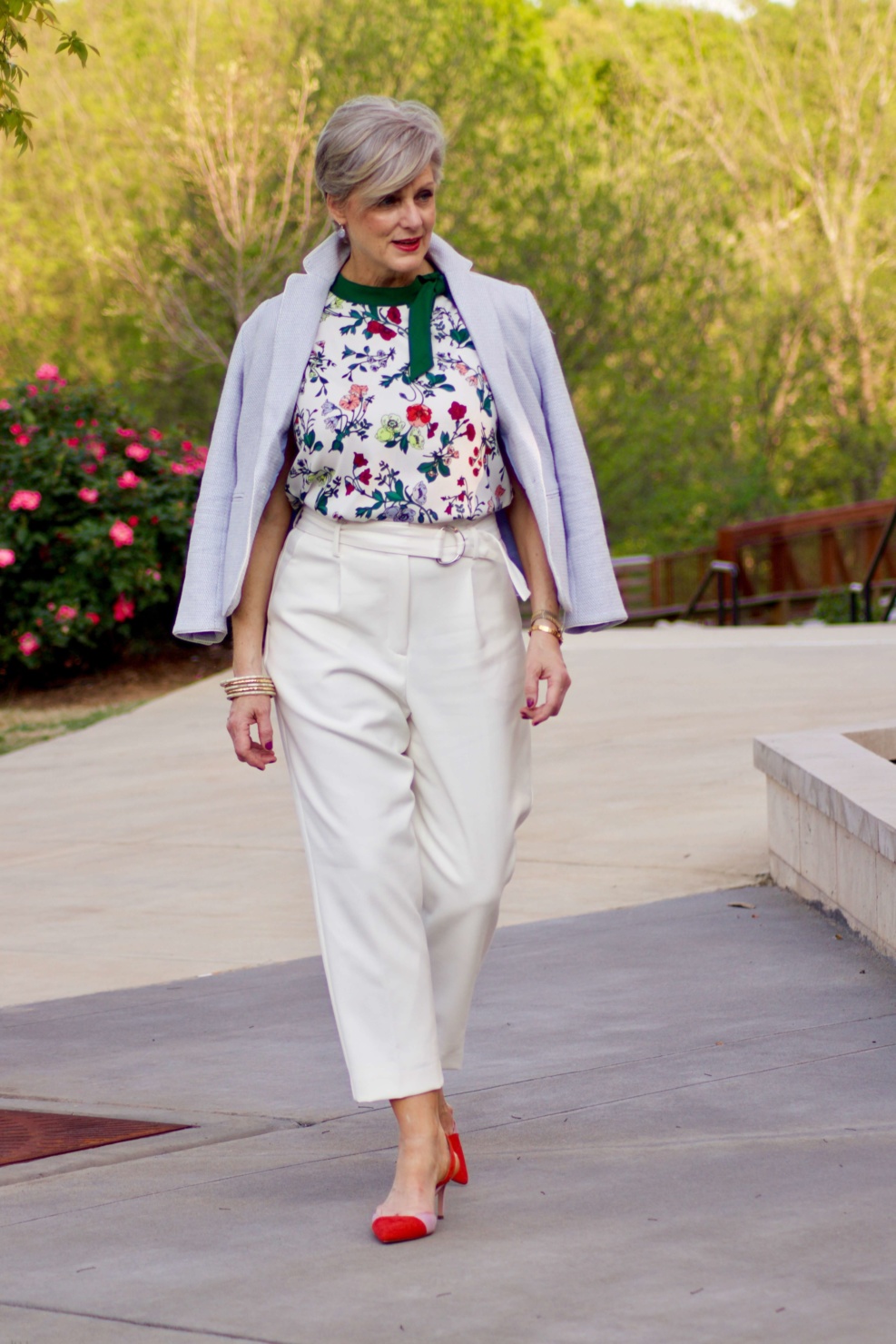 beth from Style at a Certain Age wears Ann Taylor floral sleeveless tie neck blouse, pleated pants, textured blazer, and suede slingbacks