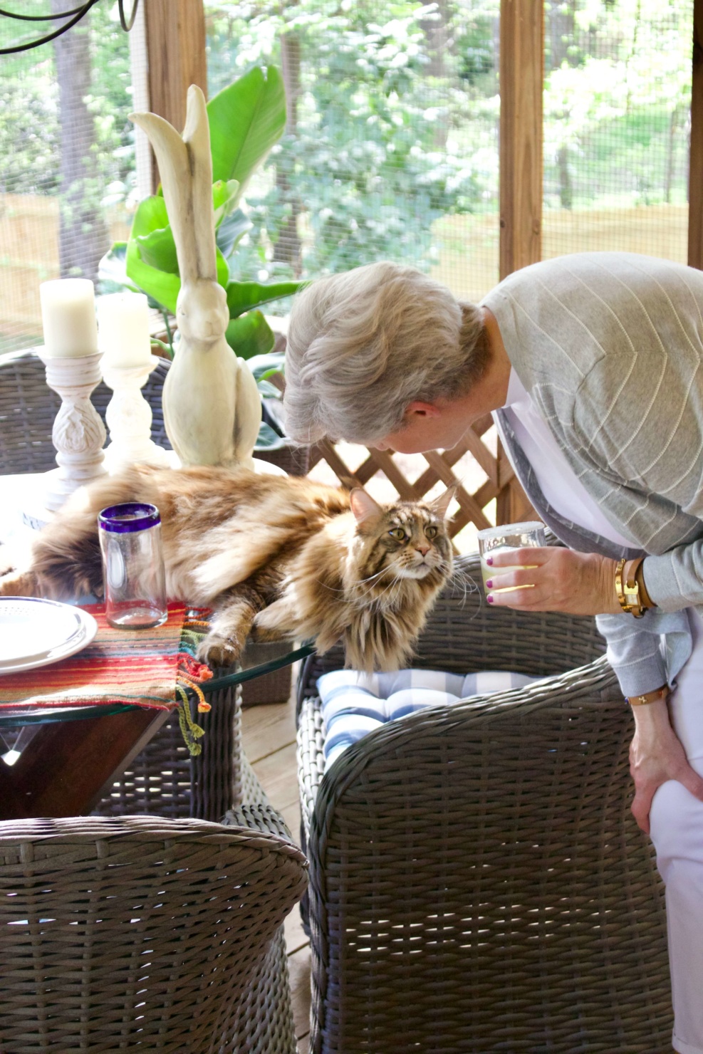 beth from Style at a Certain Age wears white girlfriend chinos, white muscle tee, gray cardigan, and brown sandals