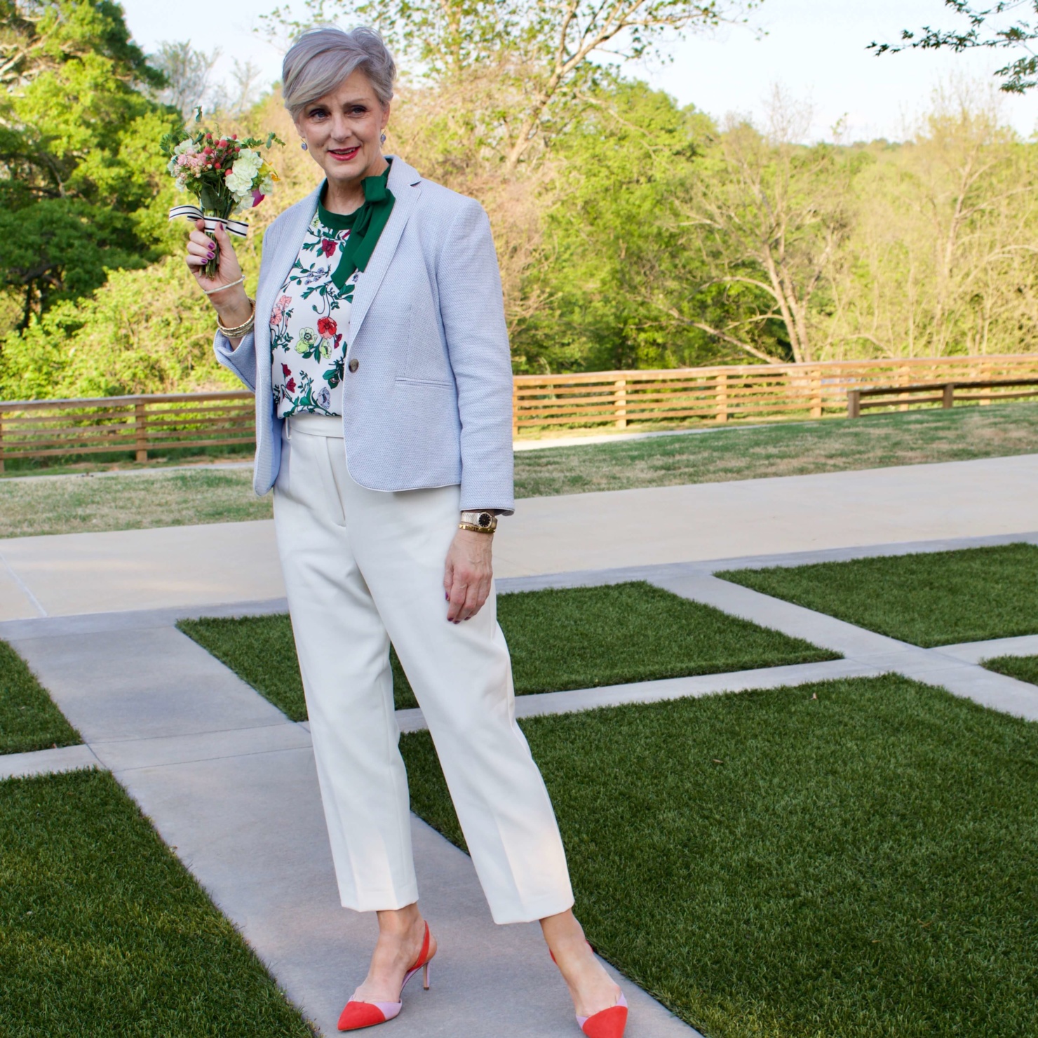 beth from Style at a Certain Age wears Ann Taylor floral sleeveless tie neck blouse, pleated pants, textured blazer, and suede slingbacks