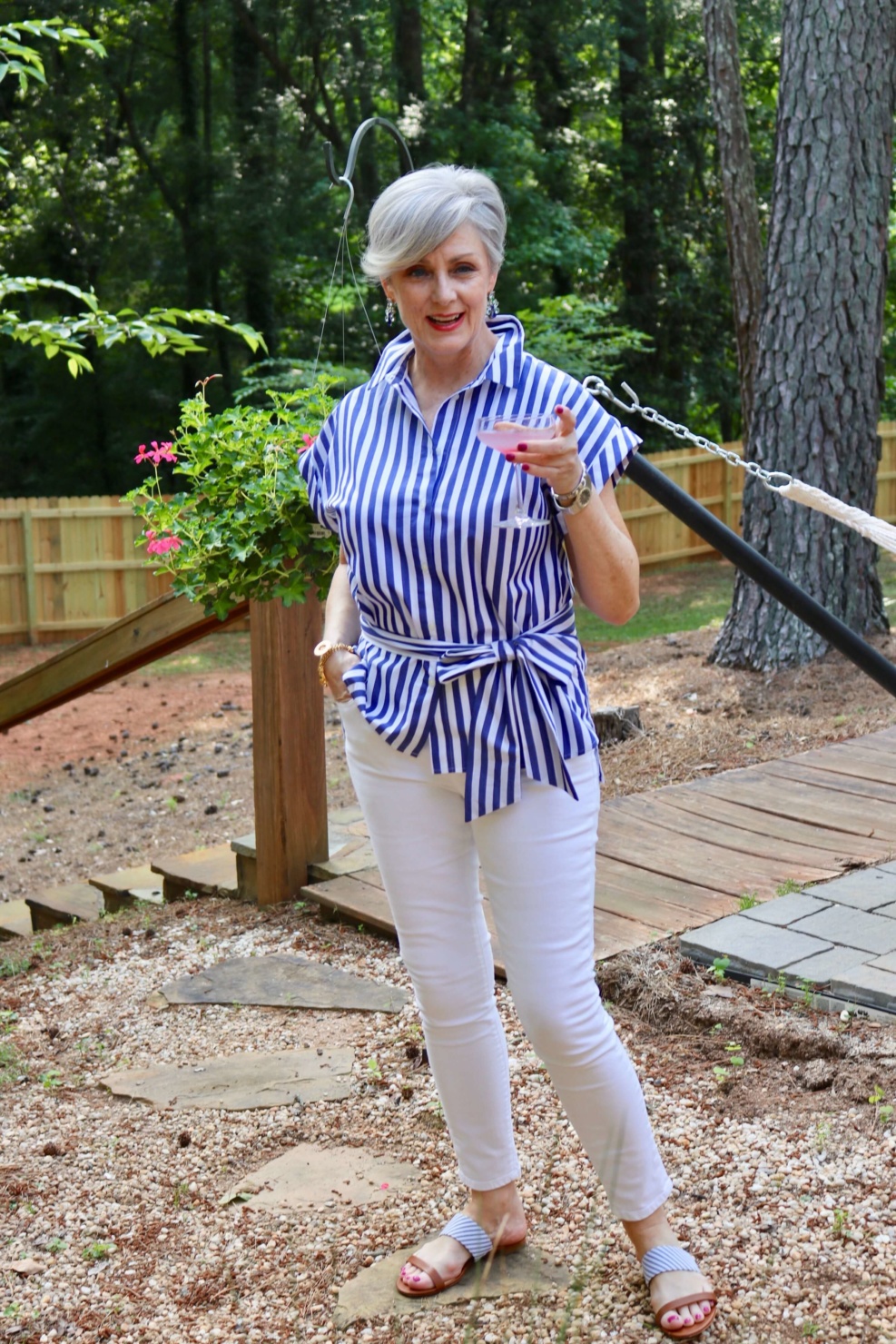 beth from Style at a Certain Age wears a striped shirt, white denim, and seersucker sandals