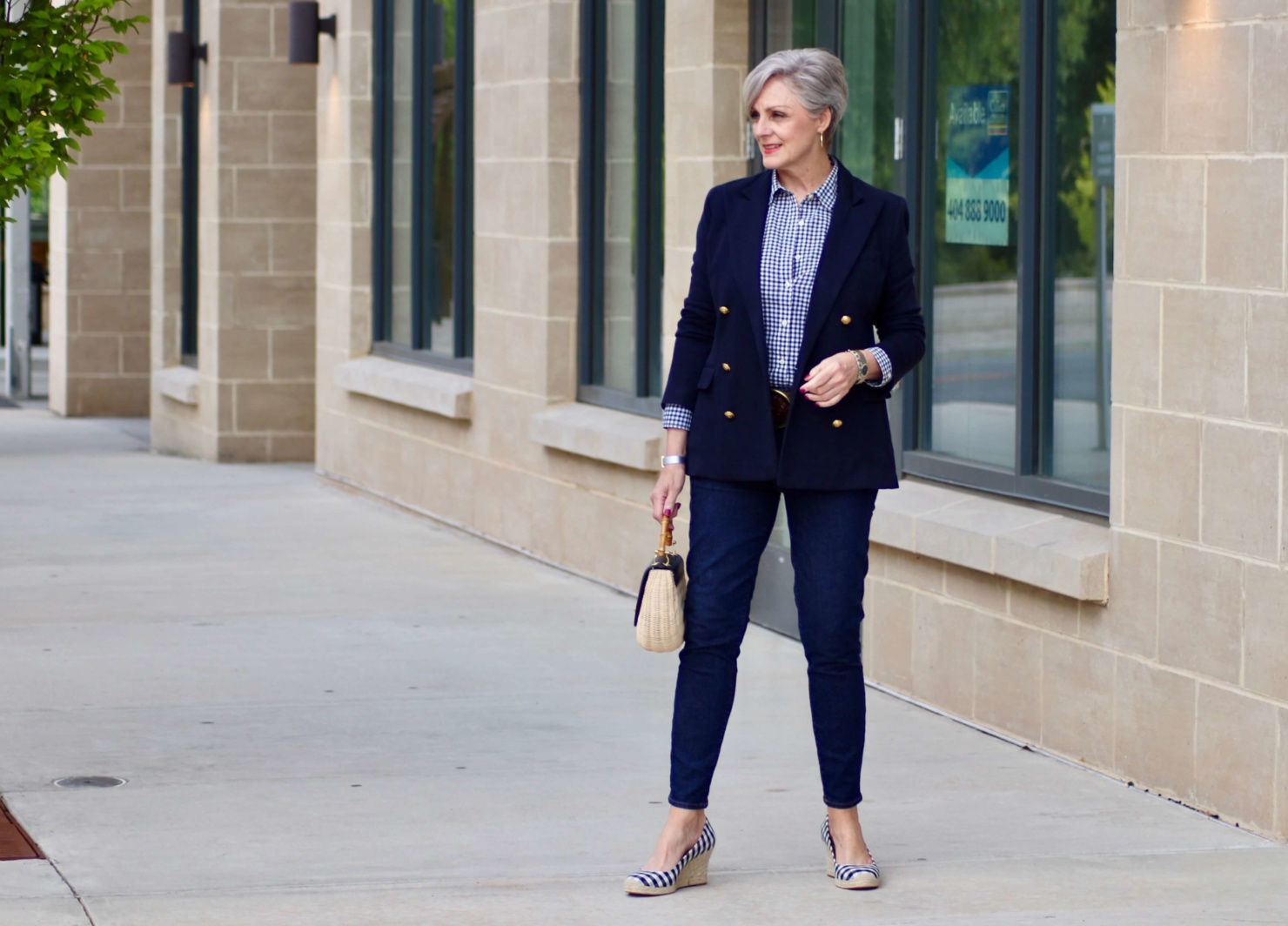 beth from Style at a Certain Age wears a lightweight blazer, gingham shirt, skinny jeans, espadrilles and wicker handbag