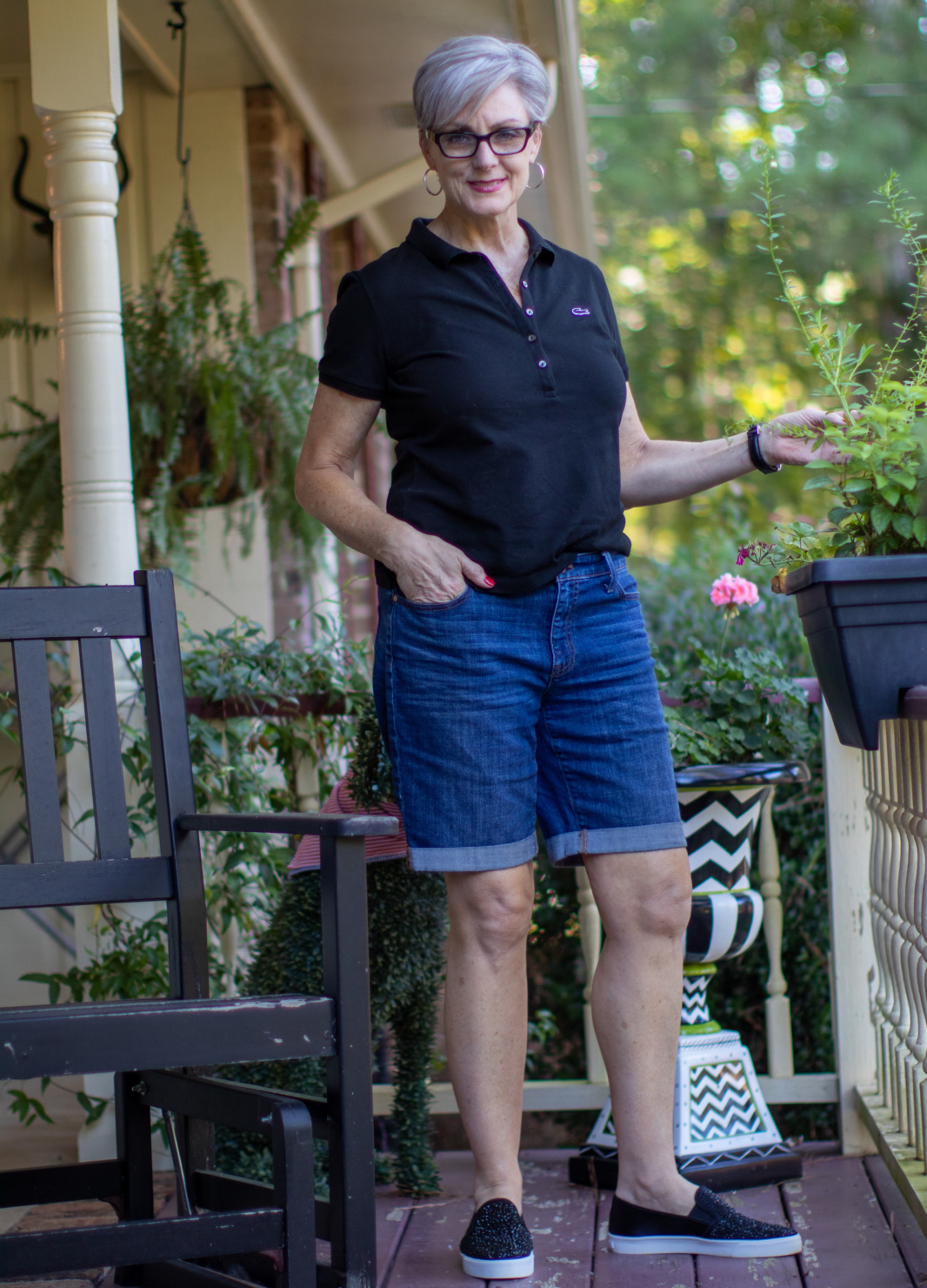 lacoste black tee, jean shorts, and black sneakers